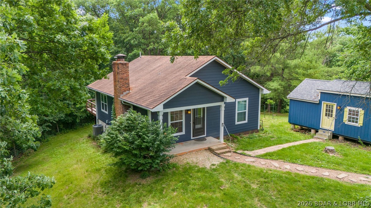 Welcome to your own slice of peaceful country living situated on 2.5 acres, this charming 2 bedroom, 2 bath home offers the perfect blend of privacy, functionality, and opportunity.Step inside and enjoy a warm, inviting atmosphere highlighted by a cozy wood-burning stove perfect for those crisp Missouri winter nights. Outside, you'll find a spacious 12x15 deck, ideal for relaxing and taking in the quiet surroundings. For those dreaming of a hobby farm or equestrian setup, this property delivers with a 40x50 pole barn complete with horse stalls and tack area, plus plenty of room for horses, gardening, or expansion. The fenced acreage and gated driveway with security system provide both peace of mind and convenience. Looking for extra income or guest space? This property includes a separate tiny home featuring a full kitchen, bathroom, and its own heating and cooling via mini-split system perfect for rental potential, Airbnb, or extended family. Enjoy the serenity of country living while still being just minutes from restaurants, shopping, and amenities in Fulton