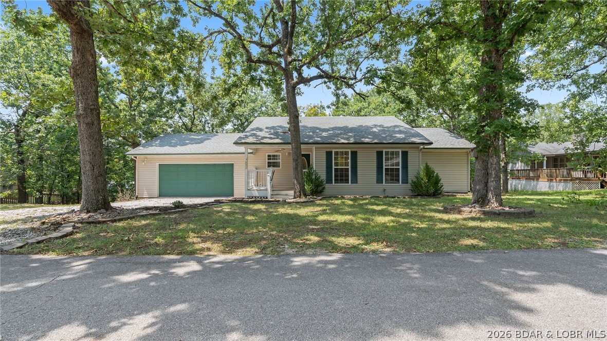 Discover this well-maintained 2-bedroom, 2-bath home tucked away in a peaceful Osage Beach neighborhood, offering the perfect balance of privacy and convenience. Thoughtfully cared for and move-in ready, this home features an attached oversized two-car garage and an inviting open-concept layout that seamlessly connects the living room and kitchen. The kitchen offers tile flooring, a breakfast bar, and plenty of space for everyday living or entertaining. Both spacious bedrooms provide private access to the expansive back deck, where you can start your mornings with coffee while enjoying the tranquil wooded views and sounds of nature. Conveniently located just minutes from shopping, dining, entertainment, and Lake Regional Hospital, you'll appreciate the easy access to everything Osage Beach has to offer while still enjoying the quiet setting away from the summer traffic. If you've been searching for a well-maintained home in a desirable location, this one is a must-see. Call for a private showing today!