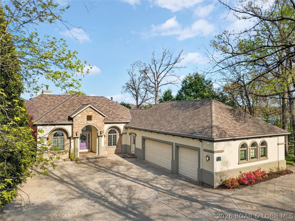 Major $200,000 Price Reduction! Welcome to this exceptional waterfront estate in prestigious Porto Cima, offering breathtaking main channel views and luxury living at Lake of the Ozarks. Extensive recent improvements include approximately 2,500 sq. ft. of new carpet, a freshly painted pool deck, refinished poolside cabinetry, and numerous additional upgrades that make this home feel brand new and truly move-in ready. Featuring 5 en-suite bedrooms, a gourmet kitchen with Wolf & Sub-Zero appliances, elevator, main-level primary suite, office, 3 kitchens, 3 laundry areas, 5 fireplaces, and an expansive lower level with family room, wet bar, billiards, and gaming area. Resort-style outdoor living includes a pool, spa, fire pit, outdoor kitchen, and bar. The 42x62 dock offers an 18x54 slip with 24,000-lb Poly Lift, dual PWC lift, private wave breaks, touchless cover, dock shed, and a gentle concrete walk to the water. Turnkey and minutes from the Bagnell Dam Strip, Backwater Jack's, and Dog Days. Ask about the boat available separately.