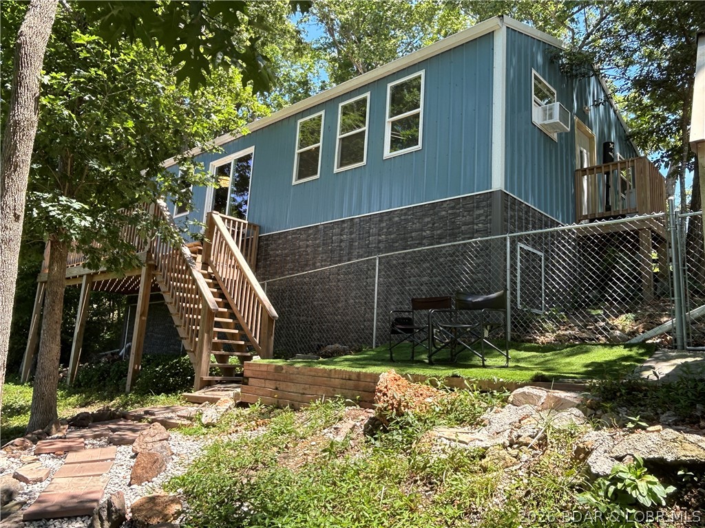 Wow what a great home!  The new one level home has a great elevated view of the lake with a lake easement.  Seller says deeded lake access to nice flat rock beach to lay out on or spread blankets or chairs, really super nice for swimming!  The sellers kayak across the lake to Coconuts!  The 3 br 1 bath home looks out onto a nice deck and the fenced yard.  Additionally there is a rental or guest cabin that has water in it and a loft and the super shaded deck overlooking the lake, real nice opportunity for a rental whether long term or nightly per seller.  Always a nice breeze, sunset, privacy at this property!  Room for a garden as well.  A third building is set up for a dog kennel and storage but can be anything.  The on site sewer system is a holding tank that relieves you of lateral line worries and expense, pump out once or twice a year, grey water useage heads to lateral lines per seller.  COMO internet is $50/mo.  Seller has done a nice job landscaping outside with oversize rock and gravel.  Come look at this property if it matches your criteria and buy it!  Email or call for more pics or info.  Let's make a deal !