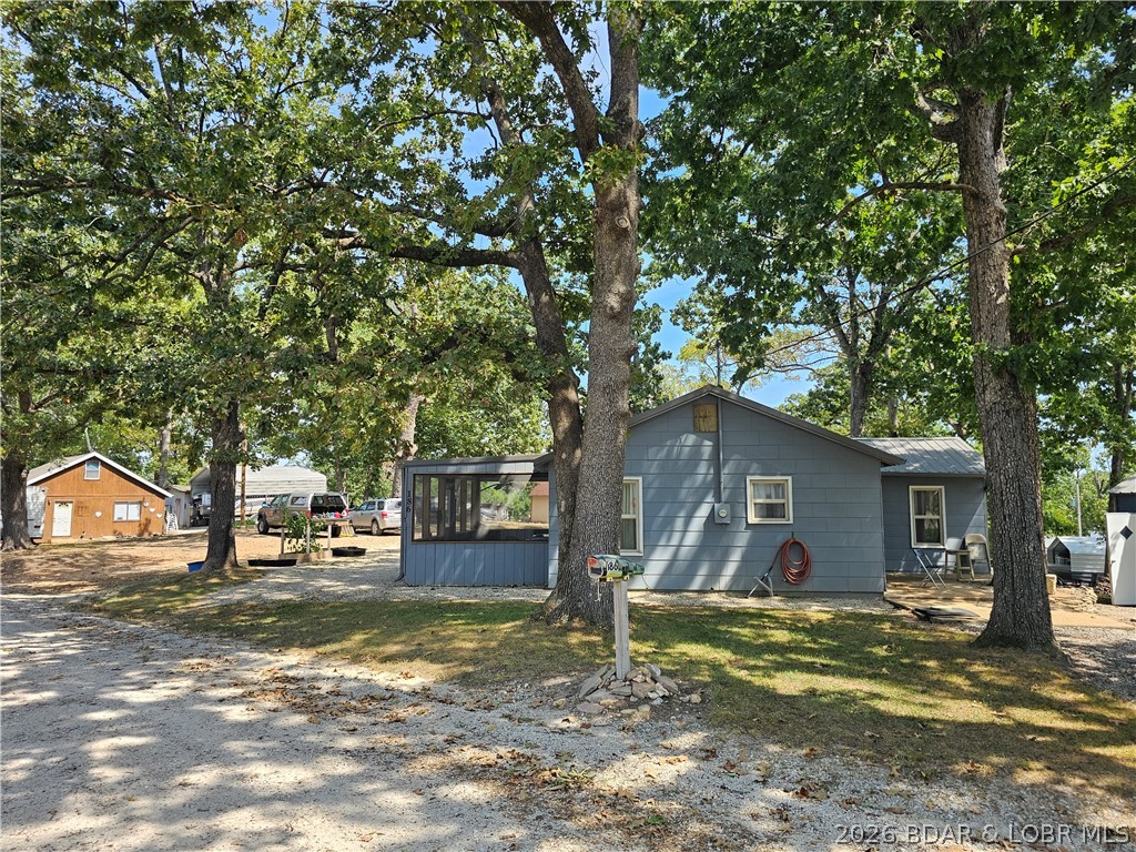 MOTIVATED SELLER. Charming 2-bedroom home (one non-conforming) ideal for a weekend getaway, hunting or fishing cabin, or starter home. Enjoy lake views from the large screened-in porch, perfect for relaxing after a day outdoors. The property includes two newer insulated metal buildings on concrete pads, including a 2-car garage with space for a workshop or deer-hanging station, plus a 14x25 storage shed with flexible use for equipment or hobbies. Recent improvements include a new metal roof, 200-amp electrical service, private well, and a recently inspected septic system, keeping ownership simple with electricity as the primary utility. Located in El Lago Lodges subdivision, owners enjoy access to a boat ramp, community dock, day dock, and swim area, all with no HOA fees. The home is within walking distance or a short side-by-side ride to Boondocks Bar & Grill and Lazy Dayz Resort, with multiple popular lakefront restaurants and marinas just minutes away by boat. Nearby Fiery Fork Conservation Area offers public hunting, fishing, kayaking, and outdoor recreation. Make an offer today!