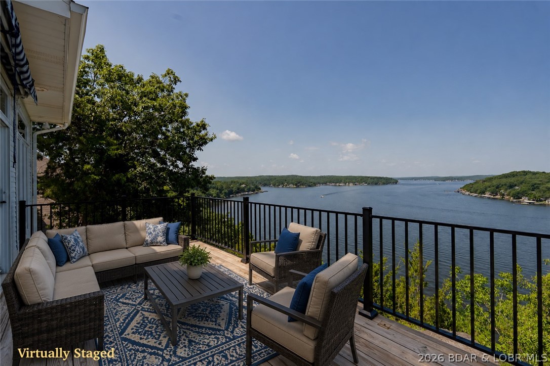 Enjoy breathtaking lakefront views for miles at this beautiful Lake of the Ozarks home. Perfect for relaxing or entertaining, you'll love spending mornings on the deck and evenings watching the sunset over the water. Bonus- take in the fireworks show from Margaritville on Summer holidays. Ideally located just minutes from Lake amenities, Lake Regional Hospital, shopping, and dining, this custom home offers a spacious floor plan with multiple gathering areas. The kitchen with wet bar opens to an oversized Four Seasons room and cozy hearth room with fireplace.The home features three bedrooms, including two en-suites, plus an office that can easily serve as a fourth bedroom. The spacious primary suite offers dual walk-in closets, a jetted tub, walk-in shower, and double vanity. Additional highlights include a formal dining room, oversized laundry room, two attached two-car garages with ample storage, a newer roof, and beautiful natural rock outcroppings. Timeless design, incredible views, and endless potential make this a rare Lake of the Ozarks opportunity. Local marinas are near by if so desired.