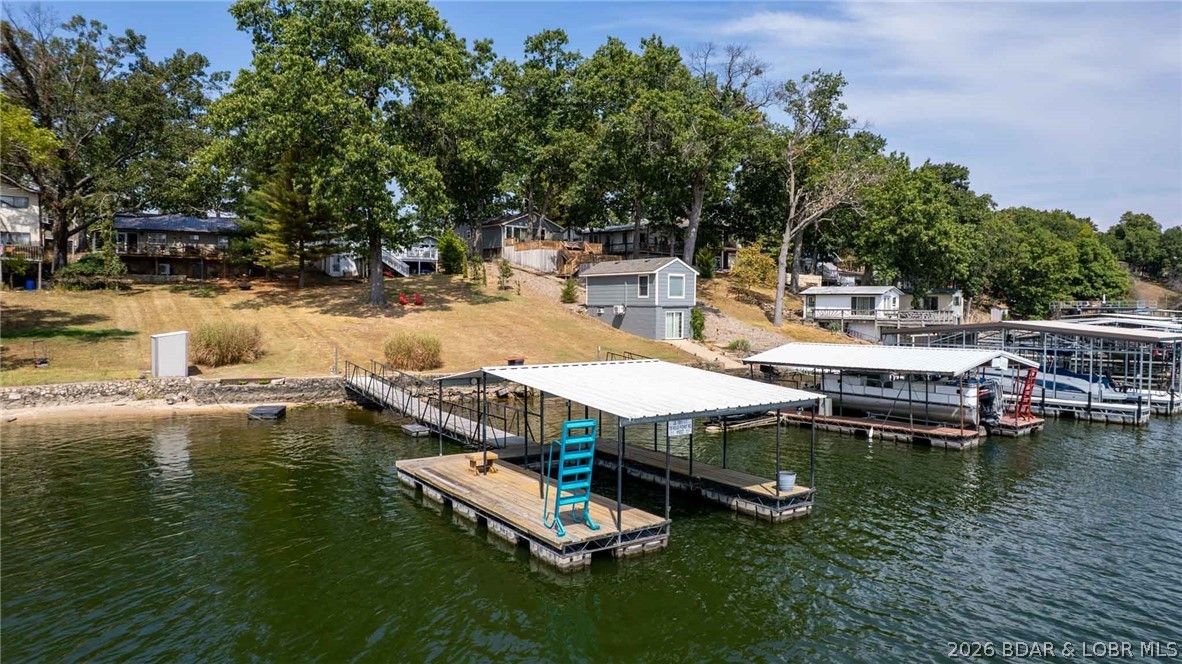 Lakefront Cabin Located at the 47 MM under $350k with Main Chanel Views!! Enjoy lake life at its best with this charming 3-bedroom, 1-bath cabin. This darling cabin comes completely furnished. Inside, you will find a recently remodeled bathroom & newer light fixtures. A durable metal roof adds peace of mind for the years to come. The dock features new wet steps & updated electrical. Whether you are searching for a weekend retreat, vacation rental opportunity, or full-time residence, this home delivers both comfort and convenience in a true lakefront setting.