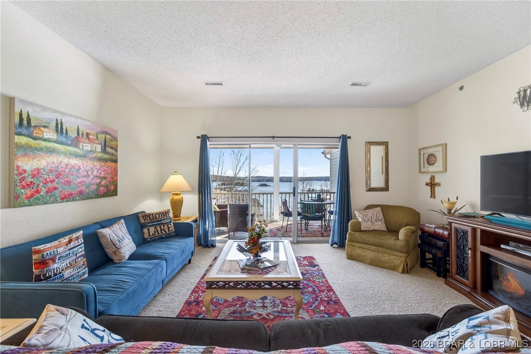 Located on the top floor at Vintage Landing, this spacious 2-bedroom, 2-bath condo offers stunning main-channel views of Lake of the Ozarks from the screened-in porch and an unbeatable central location. The flexible lockout floor plan includes a private bedroom, full bath, and kitchenette—perfect for living in one side while renting the other, or renting both, as short-term rentals are allowed. Sold fully furnished and turn-key, the condo features a newer HVAC system, a full kitchen plus kitchenette, and a full-size washer and dryer, making it ideal for full-time living, a weekend retreat, or an income-producing investment.

Assessments include access to the exceptional Four Seasons amenities, such as the new indoor pool, fitness center, multiple pools, fishing lakes, activity center, boat launches, campground, RV park, Bark Park, hiking and biking trails, parks, sports courts, swim club, tennis club, and more. Conveniently located near restaurants and entertainment by land or water, this property also offers a front-row seat to the holiday fireworks, delivering the perfect blend of lake lifestyle and investment potential. Assessments also include electric for the condo.