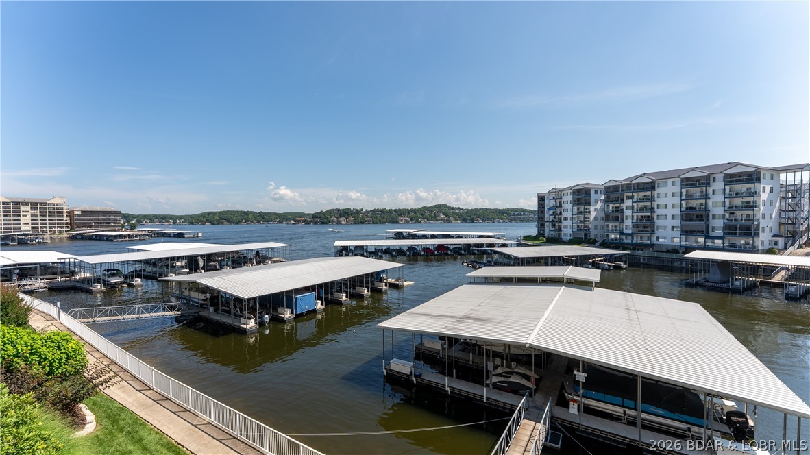 This SUPER NICE 3BR, 2.5BA condo offers the space, comfort, and views you’ve been waiting for! Experience the difference a generous 1,400+ sq ft floor plan makes—perfect for hosting family and friends who will want to extend their stay! As a highly desirable end unit, enjoy an abundance of natural light streaming through additional side windows. The updated kitchen features granite countertops and opens seamlessly to the living and dining areas. The lakeside primary suite is a true retreat with a spa-style bath complete with jetted tub, walk-in shower, and walk-in closet. Relax for hours on the deck taking in spectacular main channel views. Owners and guests love Monarch Cove for its resort-style amenities including three pools, hot tubs, outdoor kitchen, elevators, lush grounds, and a scenic shoreline walking path. New HVAC in 2021. Turnkey package includes furnishings, 12x32 boat slip with 4,000 lb lift, and a PWC slip—an easy way to get started at the Lake! Ideally located at the 2MM by water and just off Duckhead & HH by land—only minutes to Hwy 54 and the Bagnell Dam Strip area, with convenient access to popular lakeside restaurants.