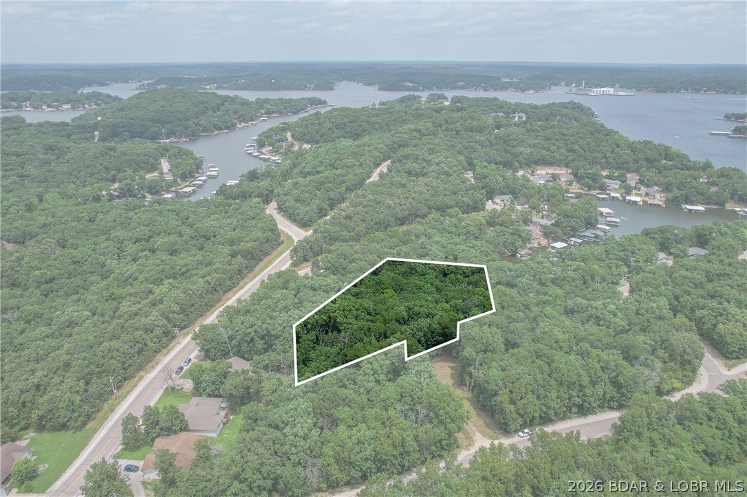 1.62-acre wooded lot in the sought-after Four Seasons community — offering privacy, space, and a blank canvas for your custom home. Opportunities like this don't come along often. Enjoy resort-style amenities including pools, a clubhouse, fitness center, tennis and pickleball courts, playgrounds, walking trails, boat ramps, and a campground. Whether you're building a forever home or a weekend retreat, this lot puts you right in the heart of the Lake of the Ozarks lifestyle.