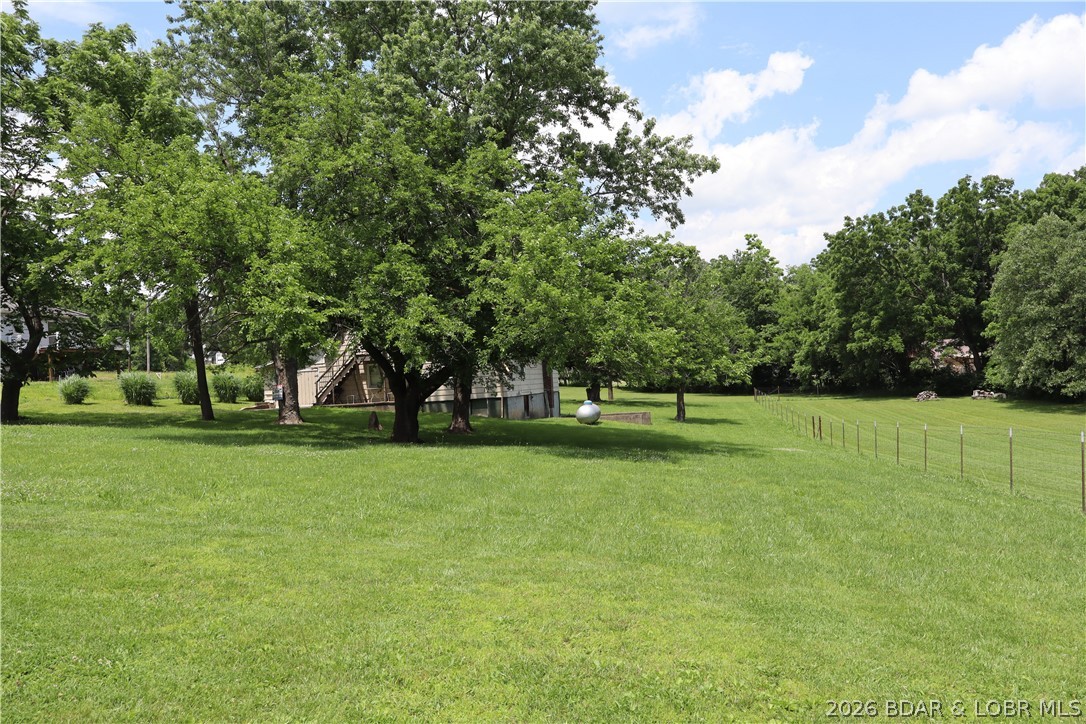 INVESTOR, HOMESTEADER & HOBBY FARMER ALERT in the Eldon School District! 4.48, private & fenced acres with diamond in the rough single family home that had been converted from a barn is available for the first time in over 30 years. Home & .480 acres in Eldon City Limits with city sewer & water. 4 fenced acres out of city limits with lean to barn for your livestock of choice to get respite from weather. Easements for city water & sewer follow the driveway & wet weather creek through acreage & would be ideal to annex into City Limits for developers. Home is being sold AS IS but used as a lucrative rental in years past. A little bit of elbow grease & updating would make it another great investment property or convert back to barn for your hobby farm. Options are endless with this property with NO ZONING RESTRICTIONS on 4 acre parcel. Propane tank to convey at closing. Call to discuss the opportunities with this property that is walking distance to Eldon South & Eldon Upper Elementary School along with Wal-Mart & other convenient shopping.