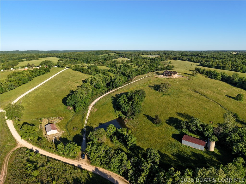 A Private Sanctuary of Beauty and Independence. Just beyond the highway lies 130 fenced acres of rolling pastures and hay fields, water features, and unspoiled nature. It is perfect for a horse or cattle ranch. This distinguished property invites you to finish a 4,000+ sq. ft. custom home to fit your personal style, complete with a three-car attached garage and a detached shop with electric. Designed for discerning buyers seeking both luxury and self-sufficiency, the estate includes solar power with battery backup, geothermal heat, and two wells. Enjoy your own spring-fed pond, and cave — a setting that’s as functional as it is enchanting. Discover the option of off grid living if desired or just feel confident in cases of power outages. There is also room for a private airstrip on the ridge, as well as additional barns or buildings. This property is located just 2 miles off I-44 and is an easy drive to St. Louis, Rolla, Fort Leonard Wood, Camdenton, the Lake of the Ozarks, Springfield and Branson! This property is not just a farm; it is a chance for the Lifestyle you have always dreamed of. Sellers will consider offers for home with less acreage.