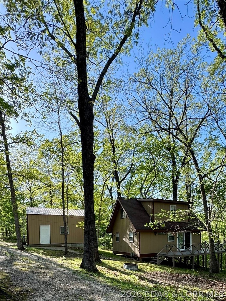 Experience the perfect lake retreat with this turn-key, fully furnished cabin nestled on three wooded lots totaling 2.75 acres—offering rare privacy, space, and value. This 2-bedroom, 1.5-bath home offers open-concept layout is filled with natural light from a new picture window, and the loft provides additional sleeping space for guests. Step outside to a peaceful deck setting, ample parking, and a 2-car garage/workshop—perfect for storing lake toys and equipment. Enjoy quick, convenient access to the community dock just minutes away, giving you all the benefits of lake life without the waterfront price tag. Recent improvements include new PEX plumbing, picture window, sliding glass door with screen and lock, and Blink security cameras. Situated on 2.75 acres across three lots, this property offers privacy, room to expand, and flexibility rarely found at this price point. This property is agent owned.

Agent owned.