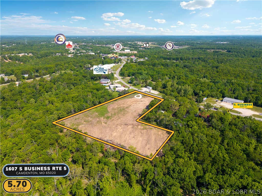 Nearly 6 acres of versatile, level ground with 250 feet of highway frontage on S Business Route 5 — one of the most accessible and visible development corridors in Camden County. Located just 2 miles from the Camdenton square and less than half a mile to the new Highway 5 interchange, this 5.7-acre B2 General Commercial tract offers a rare combination of size, location, and flexibility that is simply hard to find in this market. Suitable for commercial development, multi-family housing, mixed use, storage, or a private campus-style build, the property offers dual access and a level footprint ready for your vision. Seller is open to redivide, build-to-suit arrangements, and creative structuring — making this as flexible as it is rare.
