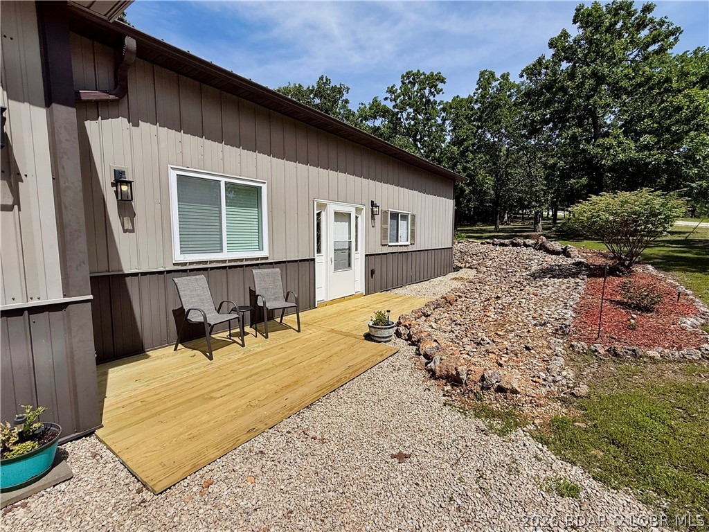 Nestled on 6.1 private acres, this exceptional 2 bed 2 1/2 bath shouse offers the perfect blend of comfortable living and functional space in a peaceful Camdenton setting. This property is ideal for those seeking room to spread out, enjoy privacy, or accommodate hobbies and recreational equipment. The open living area creates a welcoming atmosphere, connecting the kitchen and main living space for easy everyday living and entertaining. A standout feature of this property is the drive-through garage, providing exceptional accessibility and functionality. Whether you need space for vehicles, boats, ATVs, equipment, or workshop use, the pass-through design allows for effortless entry and exit, a rare and highly desirable feature for hobbyists and outdoor enthusiasts. The property offers ample room for recreation, expansion, or simply enjoying the tranquility of the surrounding landscape. With a balance of residential comfort and shop functionality, this shouse is perfectly suited for those seeking a weekend retreat, or full-time residence with space to grow. If you’re looking for acreage and privacy, here is your opportunity to own a property that offers an impressive package.