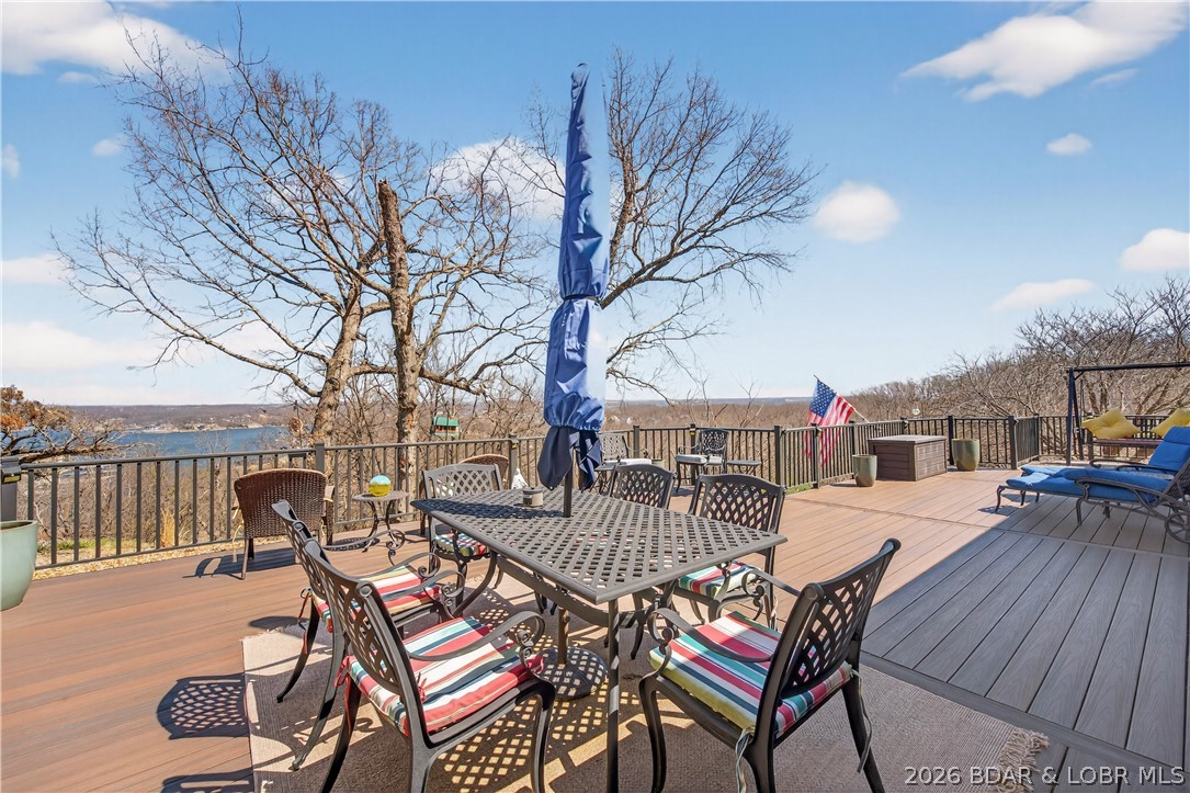 Welcome to the best condo in the complex—a rare ground-level home offering year-round lake views and effortless one-level living. This 3-bedroom, 2-bath walk-in unit features a bright, open layout with fireplace and direct access to a massive patio perfect for relaxing or entertaining with stunning sunrises and sunsets over the water. This unit can be made into a 2 bedroom with formal dining room or a 3 bedroom when space is needed. The spacious master suite is a private retreat with a walk-in shower, and large walk-in closet. Enjoy your morning coffee in the gated courtyard surrounded by your own flower garden, or take a few easy steps to the pool just across the parking lot—with five more pools throughout the beautifully landscaped community. Set on lush, sprawling acreage, this serene condo complex offers ideal spaces for peaceful strolls, evening bike rides, walking pets, or watching the wildlife. Located just off Horseshoe Bend, you’re only minutes from the Bagnell Dam Strip, local restaurants, live music, and year-round events. Convenience is key when you're at the lake! You won't want to miss the unit with the best views, schedule your showing today!