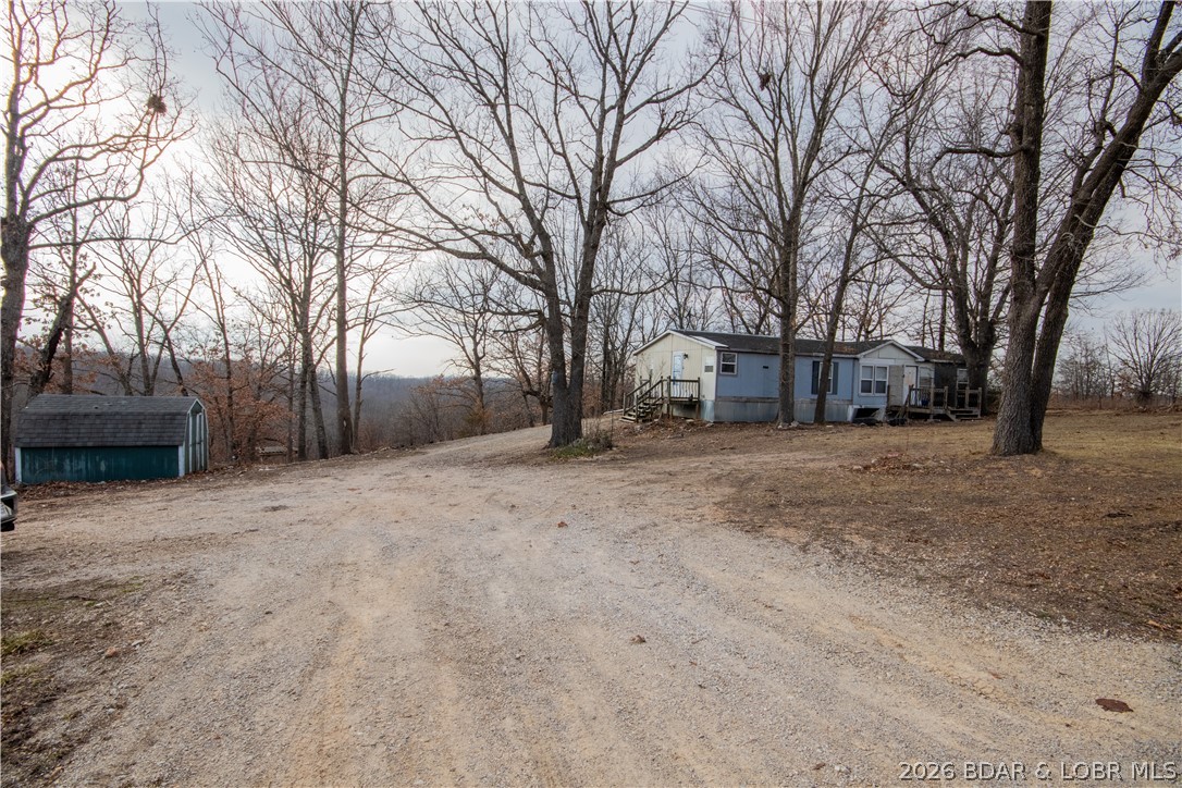 19 acres that currently houses a mobile home meaning this property is cleared for a home with electric to the site, with a well, and a lagoon.  Sitting outside of Planning and Zoning, it is the perfect location to live off the grid or turn this into your dream home location.   Right off of state Highway D which is paved right to the door being located in the Camdenton School District the school bus route runs right to the home.   The potential for a small farm or an area to hunt and build a shouse would be great for the person who needs a weekend escape.   Ideal area for a garden spot and easy access to south highway 5 via the "backdoor" which takes D road all the way to South Highway 5 near Decacturville.  19 acres  ready for your home with the infrastructure already there making for an easy new mobile home, modular, or new build.  The current mobile home will need to removed.  The owner makes no warranty to the condition of that structure and places no value on it.