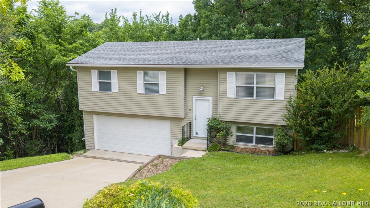 Welcome home to this inviting 4-bedroom property tucked away on a quiet cul-de-sac in the desirable Seven Trails West subdivision in Camdenton!  This home offers comfort, space, and convenience. The functional layout provides room for family, guests, a home office, or hobbies, while the partially finished lower level adds flexibility and opportunity. The second full bathroom has already been started, making it easy to finish to create an en suite 4th bedroom and add even more equity. Step outside to enjoy the large, fully fenced backyard with peaceful wooded privacy—perfect for kids, pets, entertaining, or relaxing evenings on the deck. A two-car garage offers ample storage and convenience. Located just minutes from Camdenton schools, shopping, dining, and everyday conveniences, this affordable home is move-in ready and full of potential. Don’t miss your chance to make this one your own!