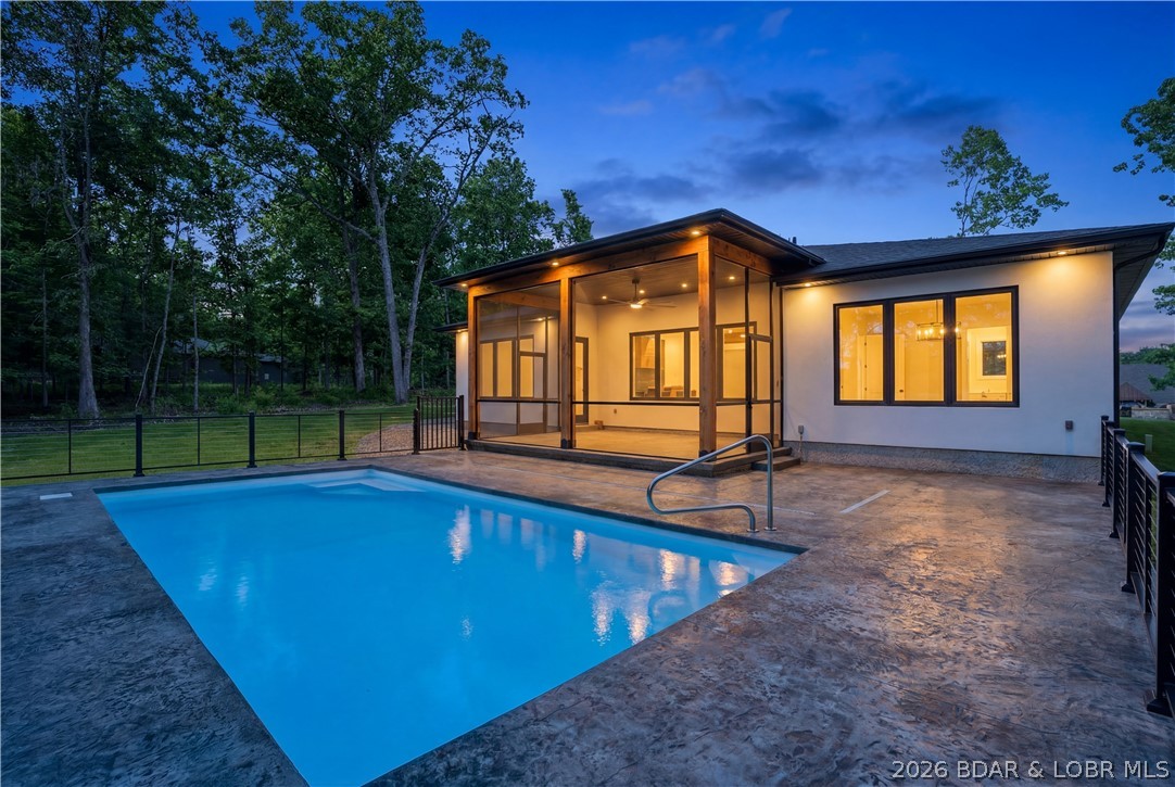 Luxury new construction in Porto Cima! You'll fall in love with this one level 3 bed 3 Bath home with your own private Pool! Enjoy the outdoors and sounds of the Lake from the stamped concrete pool deck or screened in porch. Enter through the custom built wood door and wide entryway. The fireplace feature wall is adorned with open shelving, acoustic wood paneling with LED lighting, and built in storage drawer underneath. In the Kitchen there are custom ceiling height cabinets with lighting, White Bespoke appliances, large island and tiled backsplash to bring it all together. The primary suite has access to the patio. In the primary bathroom you'll relax in your custom walk in shower with rain head. The primary closet has built in shelving and provides acess to a large laundry room with cabinets and stone counters. Coming in from the garage is a built in hall tree for great organization. The 2nd bedroom is an ensuite with dual vanity and a tiled shower and tub combo. Theres plenty of parking with the large driveway and 3 car garage. Enjoy the Eagles that live across the street! This home is just minutes from Porto Cima Golf Course and Harbor 19 if you need to rent a boat slip!