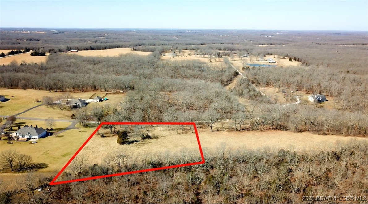 If you are looking for an incredible spot to build your dream home, in a subdivision of lavish lawns, you had better check this one out.  Is a nice yard, garden spot, or chickens something that is of interest to you?  What about an easy in and out for your RV where you can build a separate RV Garage/Man Cave?  The drive in to this stunning 3 acre parcel passes through a subdivision of homes that all are seated on 3+ acre lots, with a blacktop road to this property.  Privacy in a location that sits between Camdenton and Osage Beach with an easy backdoor to highway 7 that takes you to Lebanon or shoots you to I-44 toward Fort Leonard Wood.  These lots are hard to find at the lake!  Already cleared and open it is an easy lot to view and see all of the potential waiting  there for you.