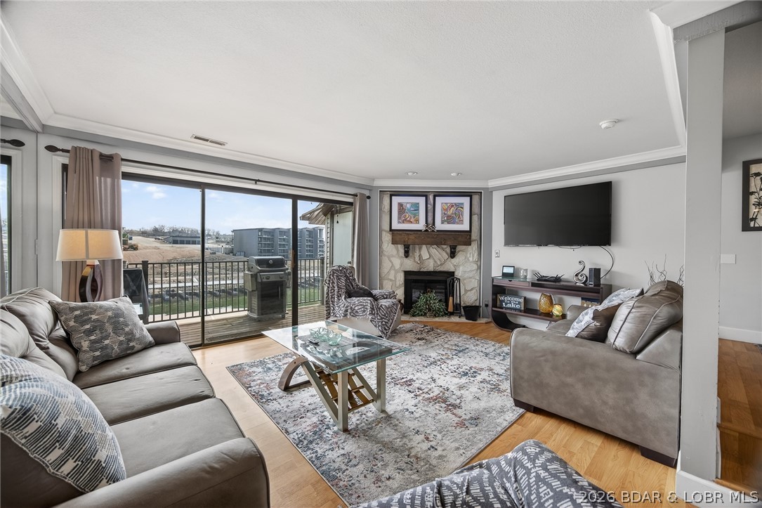 Top-floor views and lake life at its best. This 2 bedroom, 2 bath condo in a highly sought after complex is all about easy living and effortless entertaining. Wall-to-wall lakeside sliders keep those breathtaking views front and center all day long and also provide an abundance of natural light. The open layout flows perfectly, featuring a kitchen with breakfast bar and dining area, while the cozy fireplace adds warmth and charm to the living space. Some furnishings are available. The large lakeside deck is perfect for morning coffee or evening BBQs. 10x24 slip is included, just bring your boat and start enjoying the lake life. Enjoy numerous on-site amenities including a pool, clubhouse, management, security, playground, boat ramps, tennis/pickleball courts, fitness area, waterfront walking/golf cart path, firepit area, and multiple scenic, waterfront viewing areas. Conveniently located by both land and water, this is more than just a complex, it’s a true lakefront community.