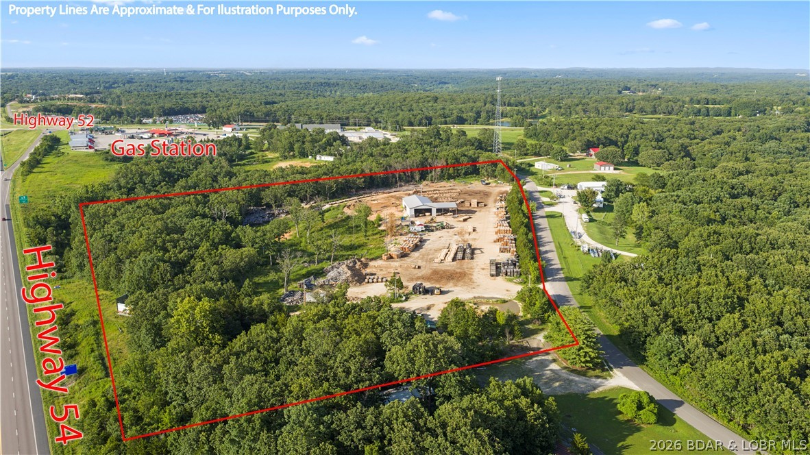 A rare opportunity to own over 18 acres of mostly cleared, level land with unbeatable visibility and direct highway frontage. Whether you're expanding your business, launching a new venture, or seeking a multi-use property, this parcel delivers the space, utilities, and infrastructure to bring your vision to life. The centerpiece is a 50' × 100' main building with robust electrical service. One end is equipped with 3-phase power — ideal for manufacturing, welding, woodworking, or any heavy-duty commercial operation. The opposite end features a dedicated RV amp hookup, making the property a natural fit for a mixed-use setup, onsite living, or a future RV park. An attached open building extends your covered workspace, offering additional storage, equipment bays, or a protected wash-down area. The land is mostly cleared and ready to develop, with room for expansion, fleet parking, outdoor storage, or even additional structures.
