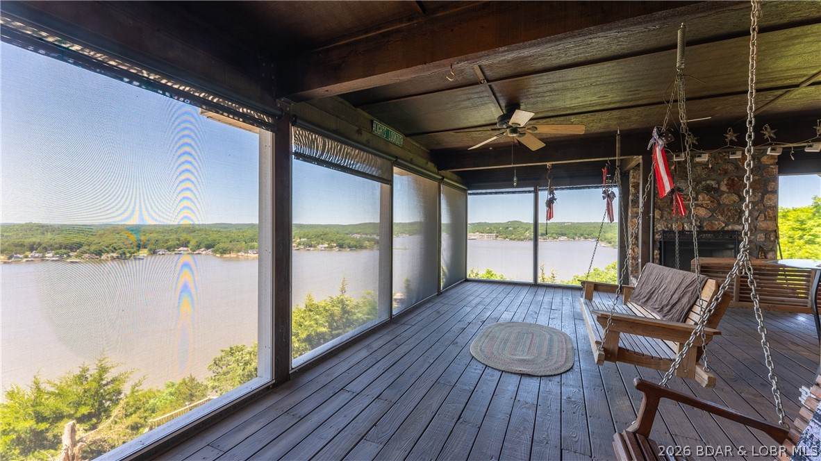 This doesn't come along every day!--unique opportunity to own 1,100 feet of bluff shoreline and over 55 acres!
Let your imagination create your dream at Lake of the Ozarks! This original owner hates to leave the peaceful, unobstructed view but says it's time for a new owners to enjoy. Property features 3 bed, 2 bath home with 2 car attached garage, detached shop/garage, tram to the lakefront, martini deck, and over 55 acres to explore. The views are spectacular from every room and the real hard wood floors and 2 massive stone fireplaces add tons of warmth and character. Lower level features open floor plan
with living, dining, kitchen, and billiards room. In addition, the large screened porch with multiple porch swings
is everyone's favorite spot. The possibilities are unlimited so come check out this one-of-a-kind property and
schedule a private tour. Now includes a golf course lot at Indian Rock Golf Club and additional lots in Benton County, MO for development potential! Owner would consider financing to qualified buyer.
