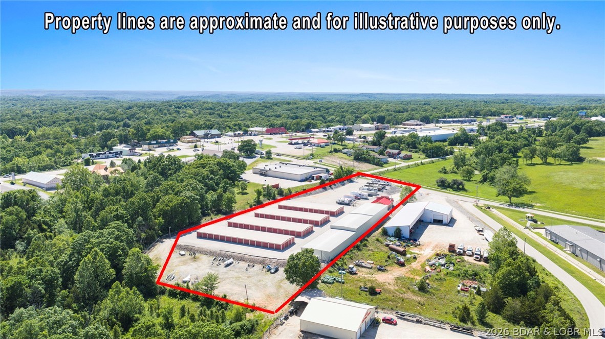Exceptional opportunity to own a fully operational, 136 unit turnkey storage facility w/on-site owner’s quarters & strong income. Thoughtfully engineered, this property features a specialized drainage & site grading system designed for long-term durability & efficient water management. The facility offers steel-frame construction with concrete foundations, approximately 2,300 linear feet of 8-foot chain link fencing topped w/barbed wire, gated keypad entry, and 187 feet of Hwy O frontage for excellent visibility & accessibility. The impressive 30x40 office building includes comfortable full living quarters, creating the ideal setup for on-site management. Updated in 2019 with newer roof and siding carrying a 35-year limited warranty.  Security has been significantly upgraded with a recently installed $20,000 LPR camera system featuring mobile monitoring capabilities, along with Ring alarm system for the office. This stabilized asset operates with near-full occupancy, dump station for recreational vehicles and expansion potential still available on-site. A rare investment opportunity combining infrastructure, security, location, and operational efficiency in one complete package.