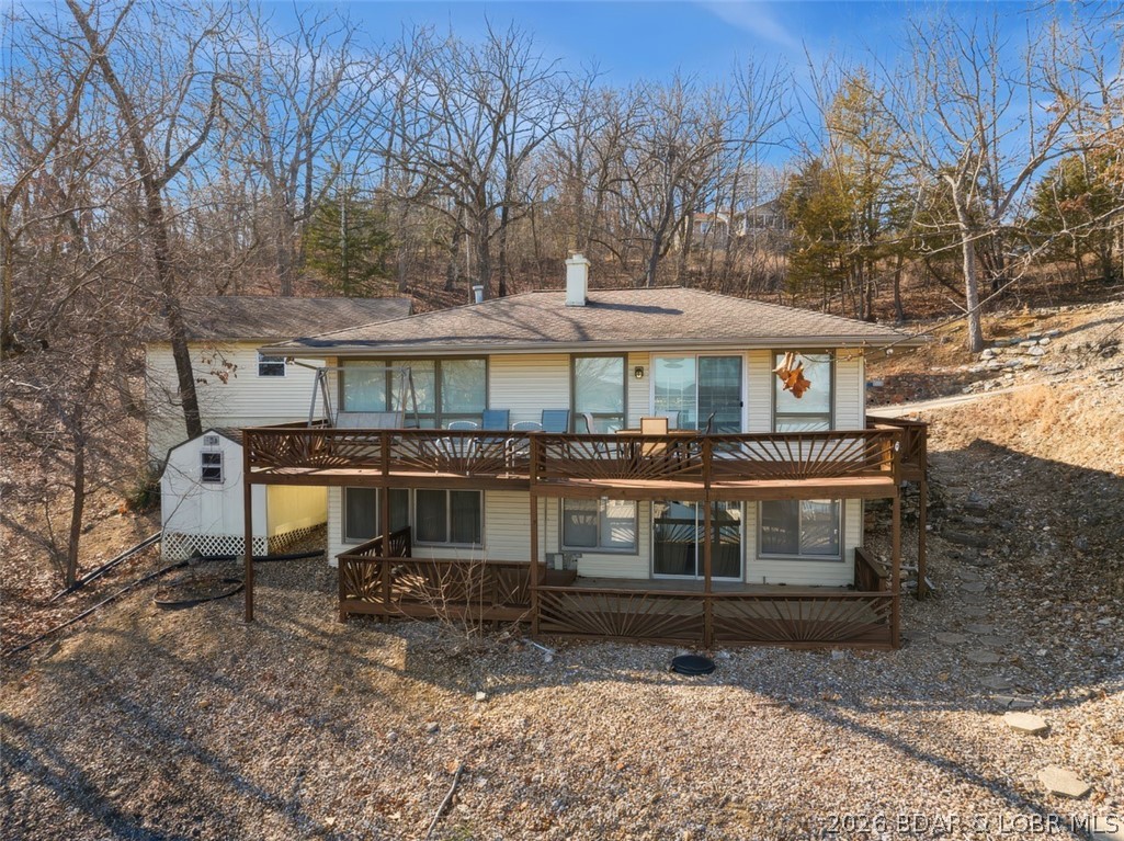 Updated Lake Front Home with Cove protection and Main Channel View.  Also, includes the 2nd Tier Lot with .72 Acres.  This Lake Home comes Furnished & the Living Room has lots of Lake View Windows, Wood Stove & Sliders to a large open deck.  The Kitchen is Tiled with extra Built-In Cabinets.  The Family Room downstairs has Rock Wall Décor, Lake View Windows and Sliders to a large Covered Deck.  2 Bedrooms & Bath upstairs and 2 Bedrooms & Bath downstairs for lots of sleeping area.  There is a Concrete Driveway, a detached 2-Car Garage, Storage Shed and easy walk to a 2-Well Dock with Boat Hoists.  Great location on the Lake & close to Paradise Restaurant.