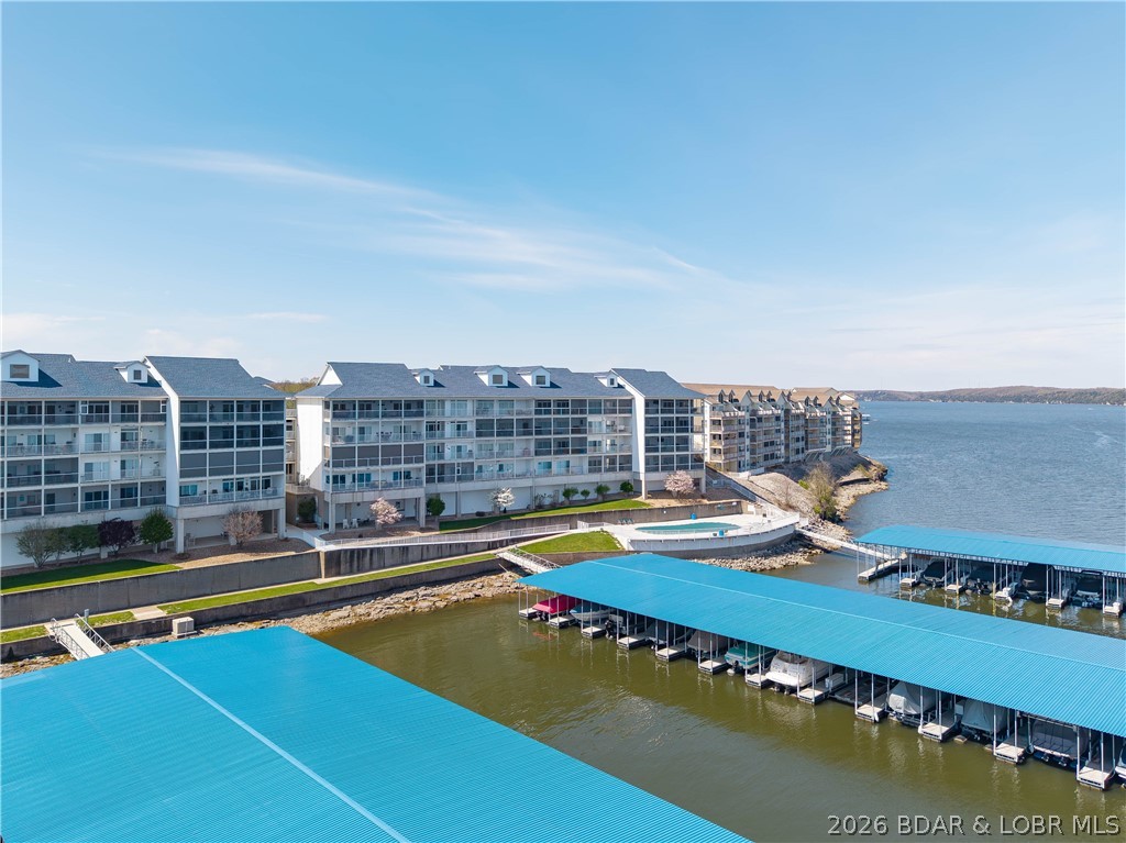 Welcome to the gated Stoneledge Condos at the 20MM, offering paved parking, a heated lakefront saltwater pool, EV charging station, pet-friendly areas, USPS mailboxes, new roofs on all buildings & garages and new docks/wave breaks. The elevator offers easy access to the condo, pool & docks. Unit #231 is a 3 bed/3 bath end-unit with two ensuites and offers 1,776 sqft of living space. The lakefront primary suite has a walk-in closet and shower and offers access to the screened-in private deck that spans the entire length of the condo. The kitchen has beautiful quartz counter tops & backsplash, GE stainless appliances, custom cabinetry and pull-out cabinet organizers! Enjoy the cocktail bar equipped with a mini frig! If the inside doesn't wow you enough, take a step onto your private patio that offers breathtaking views of the main channel. BONUS-there are newly installed remote sunshades adding that elevated level of comfort sitting lakeside! Head down to the docks & enjoy your 12x36 boat slip w/ 12,000lb lift and two PWC slips. This complex is sought after for its location and exclusivity by land & water! It's perfect for a full-time or second homeowner! Garage #9 available for $$$.