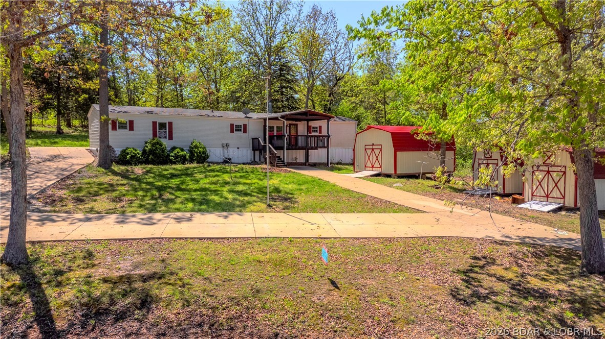 Enjoy the best of lake-area living at the 45MM, offering a perfect mix of comfort and opportunity. The home features one-level living with an open floor plan designed for gathering and relaxation, highlighted by a cozy living area with a wood-burning fireplace. Set on a spacious lot with a large front yard, the property includes three storage sheds offering ample space for tools and lake gear, along with a covered front patio that’s perfect for enjoying your morning coffee or unwinding after a day on the water.

This property has an additional lot with 75 feet of lake frontage, with electricity already installed, providing added value, privacy, and the potential to build your own custom dream home!

You’ll enjoy easy access by both land and water to local favorites, with nearby lakefront spots like Captain Ron's Bar & Grill and The Fish and Company, as well as outdoor attractions including Ha Ha Tonka State Park. Spend your days boating, fishing, or exploring the quieter coves nearby, and your evenings unwinding under the stars in a peaceful, low-traffic setting—this property delivers flexibility, charm, and a relaxed lake lifestyle.