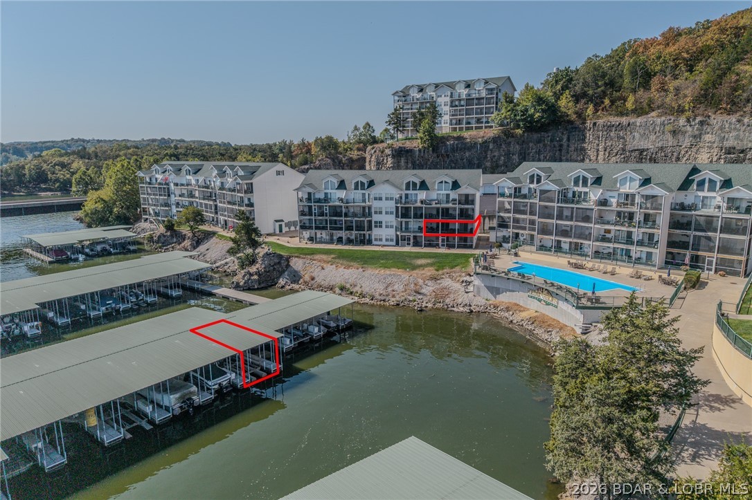 Enjoy easy lake living in this well-maintained 3-bedroom, 2-bath waterfront condo. This end unit is easily accessible from the parking lot and has an inviting covered walkway. The open-concept floor plan seamlessly connects the kitchen, dining area, and living room, creating an ideal space for everyday living and entertaining.  The primary suite features a private bathroom, while two additional bedrooms provide plenty of space for family and guests. The private screened balcony provides the perfect setting for entertaining guests or simply enjoying the beautiful surroundings. Located in the gated Cedar Heights community, you can enjoy access to multiple swimming pools, including one lakefront pool, beautifully maintained grounds, and a 10x24 boat slip, making it easy to get out on the lake whenever you want. Whether you're looking for a full-time home, weekend retreat, or investment property, this condo offers a great opportunity to enjoy everything Lake of the Ozarks has to offer.