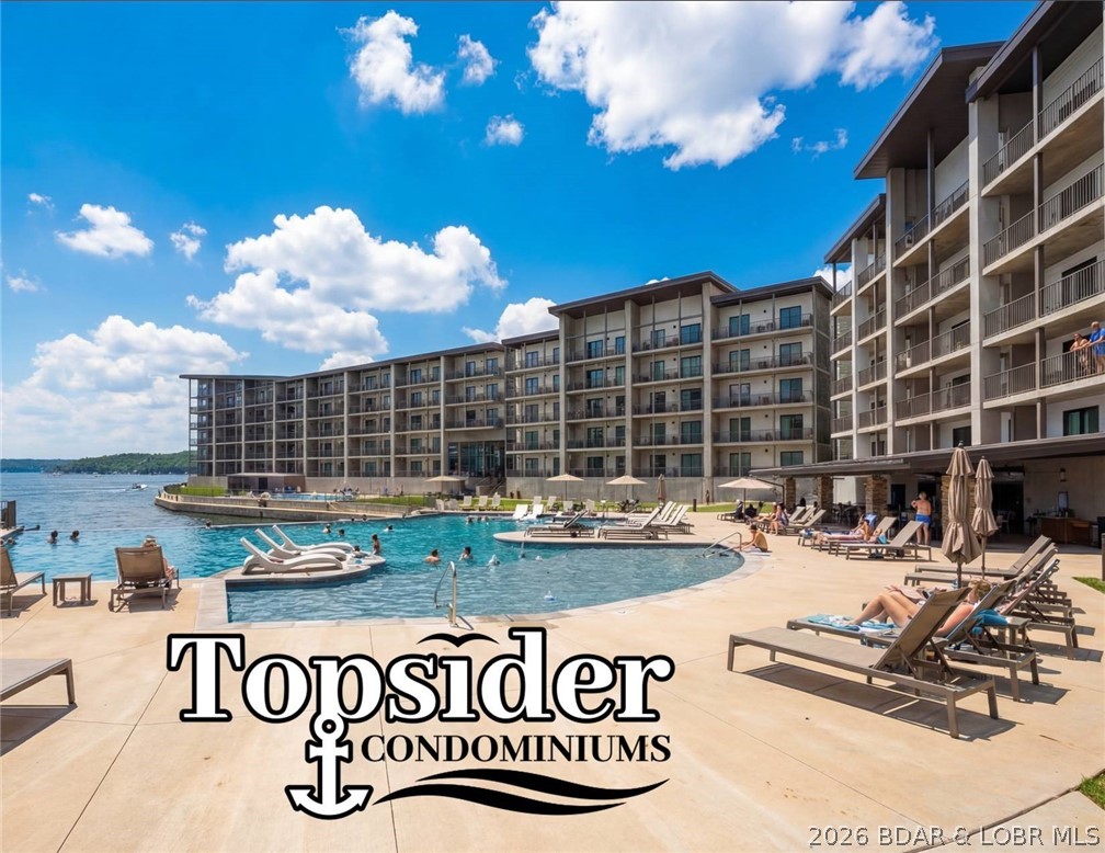Wake up to shimmering lake views and end the day watching the sunset from your private lakeside deck. Located in the newly built Topsider Condos, this fully furnished 3-bedroom, 3-bath residence offers 1,606 sq ft of modern lakefront living. Inside, an open-concept design creates a bright, welcoming space ideal for relaxing or entertaining. Floor-to-ceiling sliding glass doors in the living room and primary suite frame stunning lake views while filling the home with natural light. The seamless flow between the kitchen, dining, and living areas makes hosting friends and family effortless after a day on the water. The kitchen features quartz countertops, Koch soft-close cabinetry, and modern finishes, while the bathrooms showcase beautifully tiled showers and refined detailing throughout. Step outside onto the tiled lakeside deck, a perfect setting for morning coffee, evening cocktails, or just watching the fun. A 14 by 36 foot slip is included, offering convenient access to the lake just steps from your door. Ideally located near popular waterfront dining, shopping, and entertainment, Topsider provides the perfect blend of relaxation and vibrant lake life.