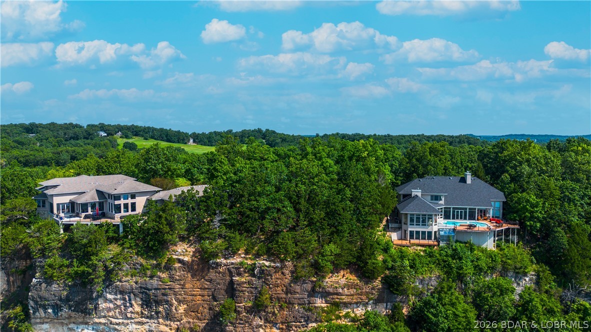 One of the last opportunities to build in prestigious Cedar Crest! This spectacular lakefront lot is located in one of Lake of the Ozarks' most exclusive gated communities, where luxury homes, manicured grounds & breathtaking views create an unmatched setting. Nearly built out, Cedar Crest rarely offers vacant lots, making this an exceptional opportunity to build your dream home among some of the area's finest residences. Offering approximately 108 ft of lake frontage and nearly a half-acre, the homesite features a level building area with dramatic bluff-top views overlooking the lake. The panoramic vistas are simply incredible and provide the perfect backdrop for a custom luxury home. Beyond the property itself, you'll love Cedar Crest's beautifully landscaped entrance complete with water features, flowers & meticulous grounds. Residents enjoy a community pool, tennis courts & a community dock where boat slips are often available. Located just seconds off Horseshoe Bend Parkway, you'll appreciate one of the most convenient locations at Lake of the Ozarks. If you've been waiting for the right lot in the right neighborhood, here is your chance to build in beautiful Cedar Crest!