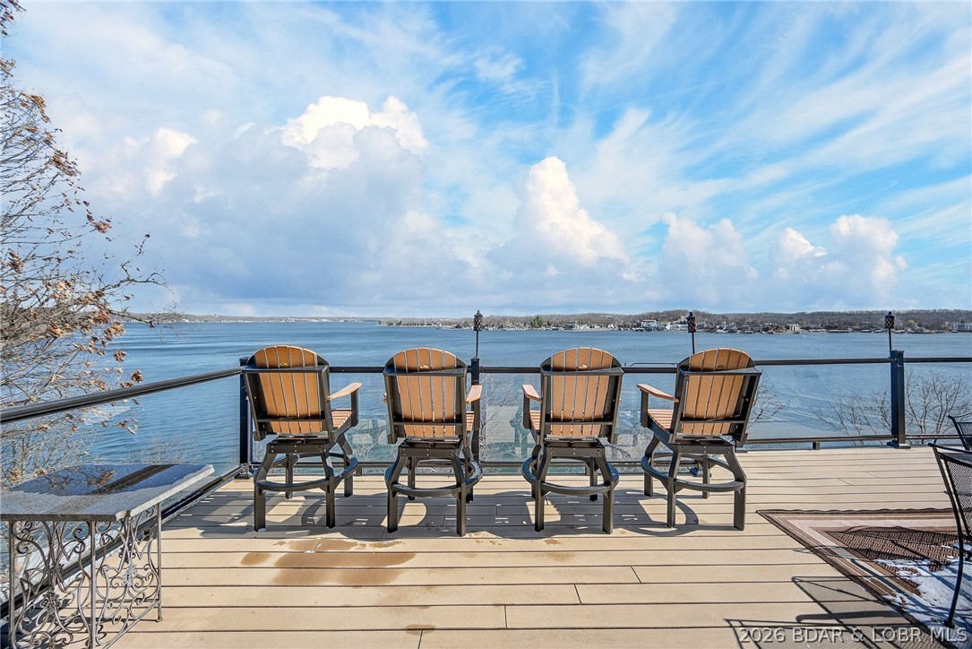 This one has it all! First is the VIEW...9 mile marker of Lake of the Ozarks!  4 spacious bedrooms with 5 bathrooms.  Walk in on the main level game room and enjoy hanging out with the gang inside or out. This floor includes 2 master suites on either end and a huge covered deck.  A few steps up to the middle level and you find the open kitchen/living room/bar area in addition to 2 more large bedrooms with extra sleep space and 2 more bathrooms.  And the Deck is the perfect place to watch boats or sunbathe.  But wait there's more...The top floor is a space all it's own with more of the fabulous views, family room, extra sleeping area and full bath.  Don't forget the firepit out front perfect for telling stories or having an evening cocktail.  VRBO income already booked with $40,000 and that's just early rentals within less of a year of being on the program.  Sleeps 22 and has overflow.  Approximately 1.06 acres +/-. Need a shop to keep all your toys? Check out mls#3584777 $299,950  This one truly is a one of a kind custom built home!