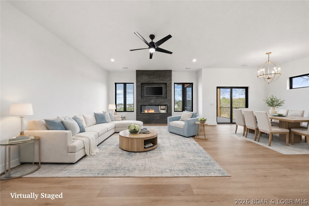 Quality construction and thoughtful design set this new lake-view home apart. Located at the 3MM of the Osage down HH, just minutes from the Bagnell Dam Strip, waterfront dining, shopping, and entertainment, this nearly 3,000 sq ft home offers 5 bedrooms, 3.5 baths, and 2 private ensuites. A striking floating staircase and wall of Anderson windows and doors fill the home with natural light while showcasing beautiful lake views. The designer kitchen features a waterfall island, hand-selected quartz and quartzite countertops, black and gold finishes, and Frigidaire Gallery appliances, including a 36-inch gas cooktop. The primary suite offers heated tile floors, Italian tile, a soaking tub, and a walk-in shower. Built with zoned HVAC, foam insulation, and a metal roof for year-round efficiency and comfort. An oversized 2-car garage with golf cart space, available boat slips, room for a pool (additional cost), and a $20,000 landscaping allowance complete this exceptional new construction.