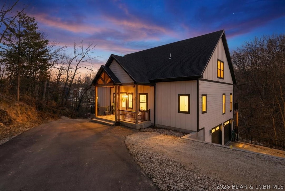 Experience the best of lakefront living at the 1-mile marker in the heart of Lake Ozark. This custom built 4-Bedroom, 4-Bath home, completed in 2024 offers approximately 3,325 Sq Ft of thoughtfully designed living space and an impressive 263' of lake frontage in a prime location. The Kitchen is a true gem featuring Quartz countertops, double wall ovens, and an expansive walk-in pantry. Flowing seamlessly into the main living area, you'll find soaring vaulted ceilings that create a grand feel with tons of natural light. You will love the cove protected waters, exceptional privacy, and unbeatable convenience - Just minutes by water or land to popular waterfront destinations and the iconic Bagnell Dam Strip. Designed for both entertaining and everyday comfort, this newer construction home combines modern finishes with the relaxed luxury of lake life. No HOA restrictions provides flexibility for full-time living, a second home getaway, or investment potential. Rarely does a newer custom lakefront home with this much frontage and this central location come available. PRICED UNDER APPRAISED VALUE PROVIDING INSTANT EQUITY!