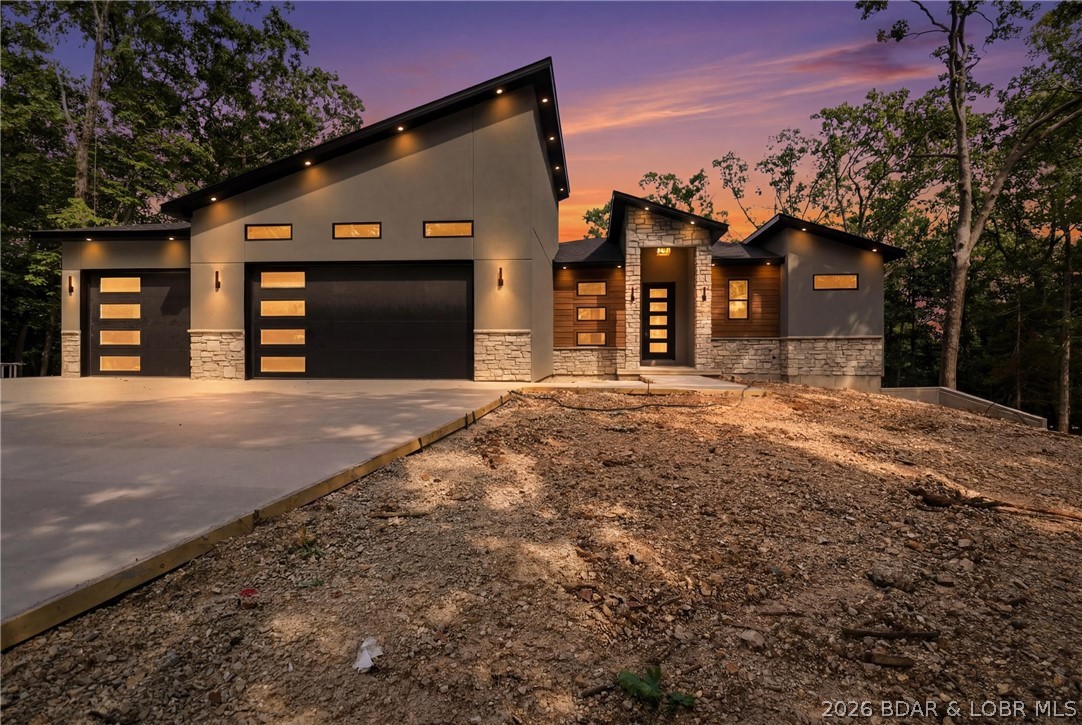 Luxury craftsmanship meets Lake living in this exceptional new construction home in the prestigious The Villages at Shawnee Bend. Situated on a private wooded second-tier lot with seasonal lake views, this 4-bedroom, 3.5-bath home offers over 3,200 sq. ft. of thoughtfully designed living space with an open-concept floor plan.
Quality construction includes 2x6 exterior walls with spray foam insulation, Pella aluminum-clad windows and sliding doors, KraftMaid cabinetry, quartz countertops, Forno appliances, and an LG washer/dryer. The exterior features stucco, natural limestone, and LP® SmartSide® siding, while the approximately 2,400 sq. ft. concrete driveway provides ample parking for family & guests.
Enjoy the privacy of a wooded setting just minutes from boating, dining, golf, and entertainment. Premium finishes, exceptional craftsmanship, and an unbeatable Lake location make this home one you won't want to miss.