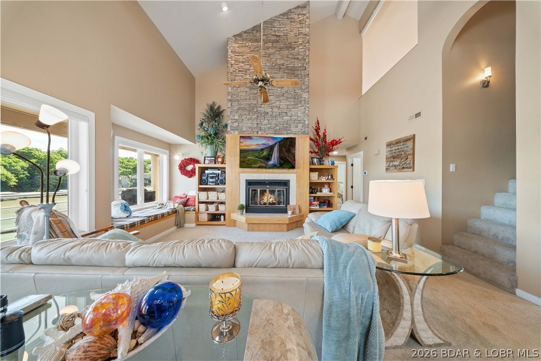 Enjoy incredible main channel views from this spacious, fully furnished top-floor end unit at Emerald Bay. With 2,089 sq. ft., 4 bedrooms, and 3 baths, all that's left to do is move in and start enjoying the lake. Conveniently located just one level up from parking, the open floor plan is ideal for entertaining, while the loft with a full bath creates the perfect second living area, guest suite, or extra sleeping space. The kitchen features Cherry Omega cabinetry, quartz countertops, stainless steel appliances, and a custom bar with a wine refrigerator and roll-out shelving. You'll also appreciate the separate laundry room and generous storage throughout. Recent updates include new carpet, interior doors, trim, can lighting, LVT flooring in closets, deck carpet, new living room and north windows, beautifully remodeled hall and primary baths, and a modern electric water-vapor fireplace. A 12x42 boat slip with lift and a 12x24 PWC slip with lifts are included. Nightly rentals are allowed, making this an excellent full-time home, vacation getaway, or investment property.