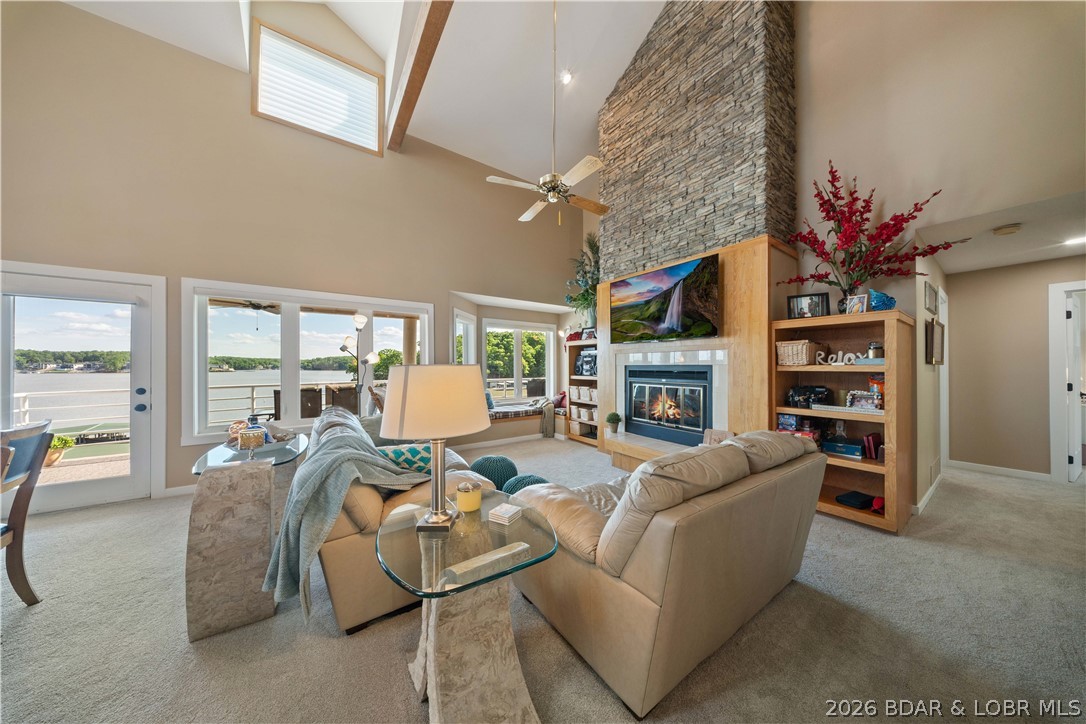 Big views, rare space, and a layout that actually makes sense—this top-floor end unit at Emerald Bay stands out from the rest. Sold turn-key, this 4-bedroom, 3-bath condo offers 2,089 sq ft and is only one level up from parking for easy access. The open living area flows right to the deck where the main channel views steal the show, while the loft provides a second living space with full bath—perfect for guests, kids, or extra sleeping room. The kitchen features Cherry Omega cabinetry, quartz countertops, stainless steel appliances, and a custom bar with wine fridge and roll-outs. Plenty of storage throughout plus a separate laundry room with added cabinetry. Recent 2026 updates include new carpet, interior doors, trim, can lighting, LVT flooring in closets, deck carpet, and new living room and north windows. Hall and primary baths have also been updated. The electric fireplace with water vapor adds a modern touch. Includes a 12x42 boat slip with lift plus a 12x24 PWC slip with lifts. Nightly rentals allowed, making this a great full-time condo, lake getaway, or investment property.
