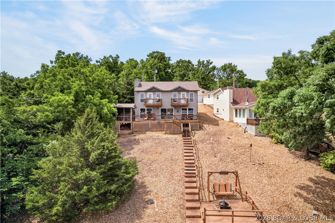 Discover the quieter side of the Lake of the Ozarks! Situated at the 60 mile marker, this beautiful 3-bedroom, 2.5-bathroom lake home offers 1,697 sq. ft. of comfortable, relaxed living space designed for hosting family and friends. Inside, you'll find an inviting, open layout with great lake views —the perfect setup for effortless weekend getaways or full-time lake living. Step outside to a fantastic deck space where you can drink your morning coffee or entertain after a day on the water. The calmer water on this stretch of the lake offers incredible fishing, smoother boating, and true lake serenity. The house comes Fully Furnished and ready to enjoy.
This property includes a massive, separate 30x30 detached garage with a poured concrete floor and full electrical—perfect for storing your boat, lake toys, or setting up the ultimate workshop. Schedule your showing today and start living the lake life! the house comes. The Boat is available for purchase separately.