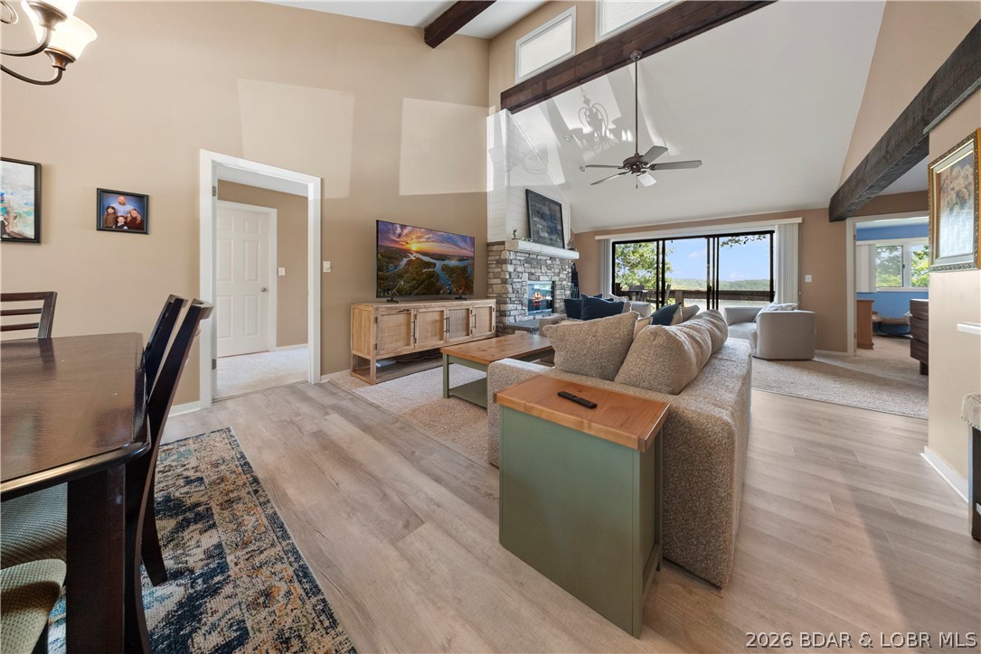 Experience the perfect blend of comfort, convenience, and resort-style living in this beautifully remodeled top-floor condo at The Knolls. With soaring vaulted ceilings, a stunning floor-to-ceiling stone wood-burning fireplace, and an open-concept layout, this home is designed to feel bright, spacious, and welcoming. The updated kitchen flows seamlessly into the dining and living areas, making entertaining effortless, while large windows showcase breathtaking sunset views across the lake. Offering 3 spacious bedrooms and 3 full bathrooms, there's plenty of room for family and guests. Enjoy peaceful mornings and relaxing evenings overlooking the water, with no docks obstructing your view. Lake days are even better with your own 12x30 boat slip and convenient parking located just steps from the dock. The Knolls is one of Lake of the Ozarks' premier resort communities, offering exceptional amenities including indoor and outdoor pools, tennis and basketball courts, a clubhouse, fitness center, playground, and more. Whether you're searching for a full-time residence, weekend getaway, or investment opportunity, this condo delivers the lake lifestyle you've been waiting for.
