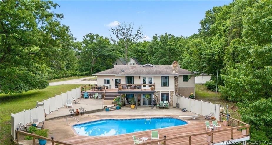 Owls Roost offers the perfect blend of space, comfort, and lake living on 2 acres with room to spread out and endless possibilities. This beautifully updated 5-bedroom, 4-bath home features potential for a 6th bedroom or bonus space and is designed for entertaining. The expansive pool area can comfortably host 50+ guests, while selective tree trimming could open up even more lake views. Inside, you'll find a remodeled kitchen with quartz countertops, induction cooktop, LVP flooring, upgraded lighting, and 3 electric fireplaces. Recent improvements include updated windows, new roof coming soon, replaced decks and railings, new flooring and carpet, an insulated garage, EV charger, updated electrical, and numerous pool upgrades. A 12x20 storage shed and additional lot provide even more flexibility. Enjoy community dock lake access, with boat slips available for rent through Alhonna Resort. With nightly rentals allowed, this property is ideal as a full-time residence, vacation retreat, or income-producing investment. NO HOA's is a plus. Quiet and peaceful, this is a must see to believe.