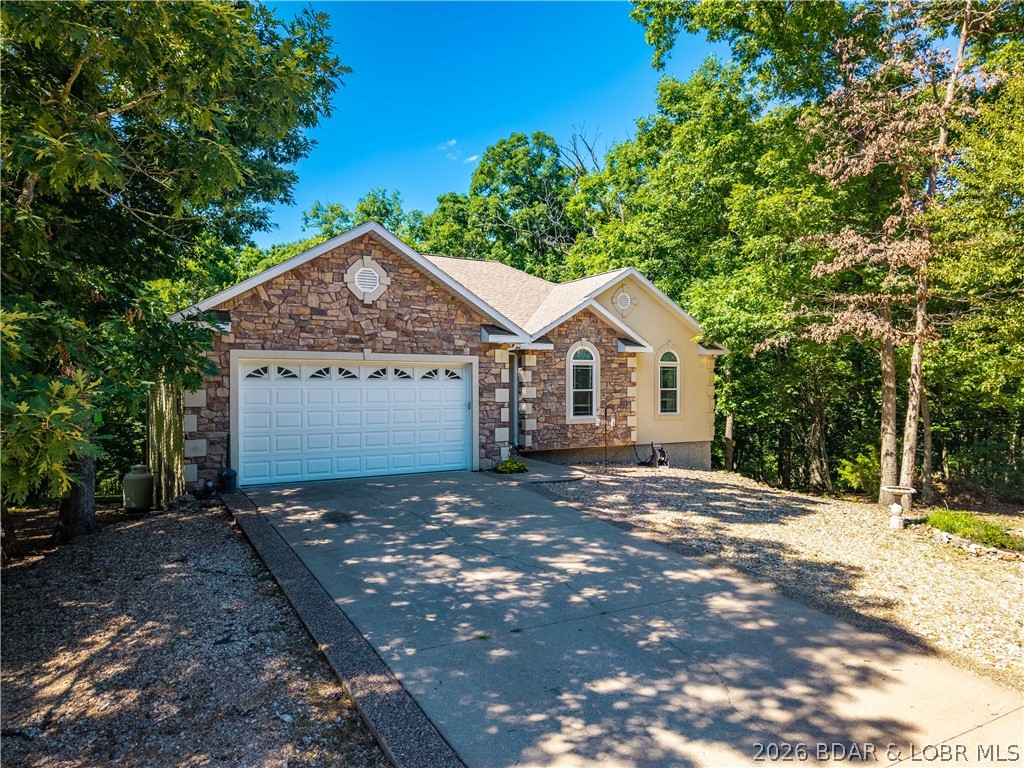Located in the desirable Four Seasons community, this well-maintained home offers space, comfort, and functionality with 5 bedrooms, 3 full bathrooms, and multiple living areas. Sits on 3 lots for privacy.  The main level features vaulted ceilings, beautiful wood flooring, a gas fireplace, and an open layout flowing into the kitchen with granite countertops, stainless steel appliances, and ample workspace. The spacious primary suite includes two closets and a jetted tub, while two additional bedrooms are conveniently located on the main level. Enjoy the screened porch and low-maintenance Trex decking overlooking the peaceful setting. The lower level offers an additional bedroom, full bath, large family room with bar area, office/flex space that could serve as a non-conforming 5th bedroom, plus excellent storage with backyard access. Situated on two lots with only one annual assessment, there is also potential to add an additional garage with ACC approval. Close to the boat launch and RV storage lot. Community indoor pool with the HOA just down the street.