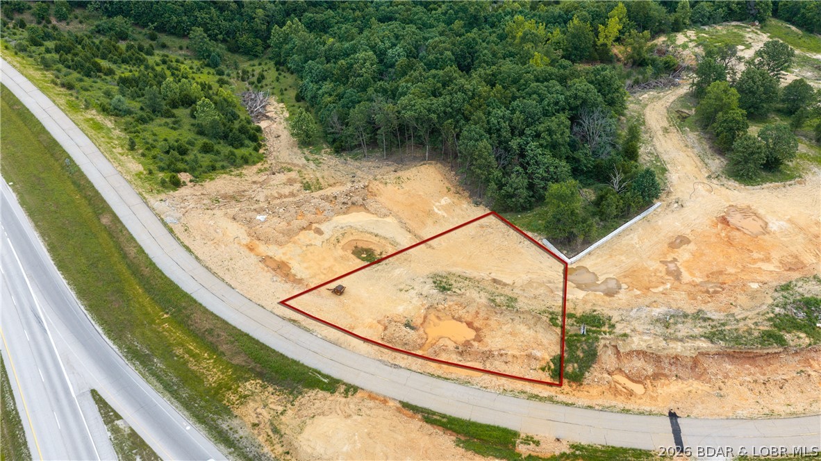 Hottest commercial property in the whole Lake of the Ozarks market, right in the Heart of Camdenton.  This property is a 1/2 acre commercial flat lot with full access to utilities.  Jack Crowell, which is located at the stoplight on Highway 54, right between Scooters Coffee & the Car Wash by Culvers.  Traffic count is over 40,000+ vehicles a day according to city officials.  Plus, this area is going to see a brand New Aldi's starting construction in August of 2026 with a completion date for August 2027.  Lil Rizzo's is building a new restaurant along with Aldi's, Jimmy John's has another half acre of ground on Jack Crowell under contract as well.  Currently, Aldi's, then a Jimmy Johns, then there is this half acre available.  The 1/2 acre lot that is being sold here, is the half acre  that is closest to the New Lil Rizzo's Italian restaurant coming on Jack Crowell.  This property is surrounded by well known business with high traffic counts:  Scooters, Culvers & the Wash Shop.  This property will be flat and at road level with City sewer, water and other utilities on site for easy access.  Looking for high traffic count & the perfect level building lots, then your search is over!
