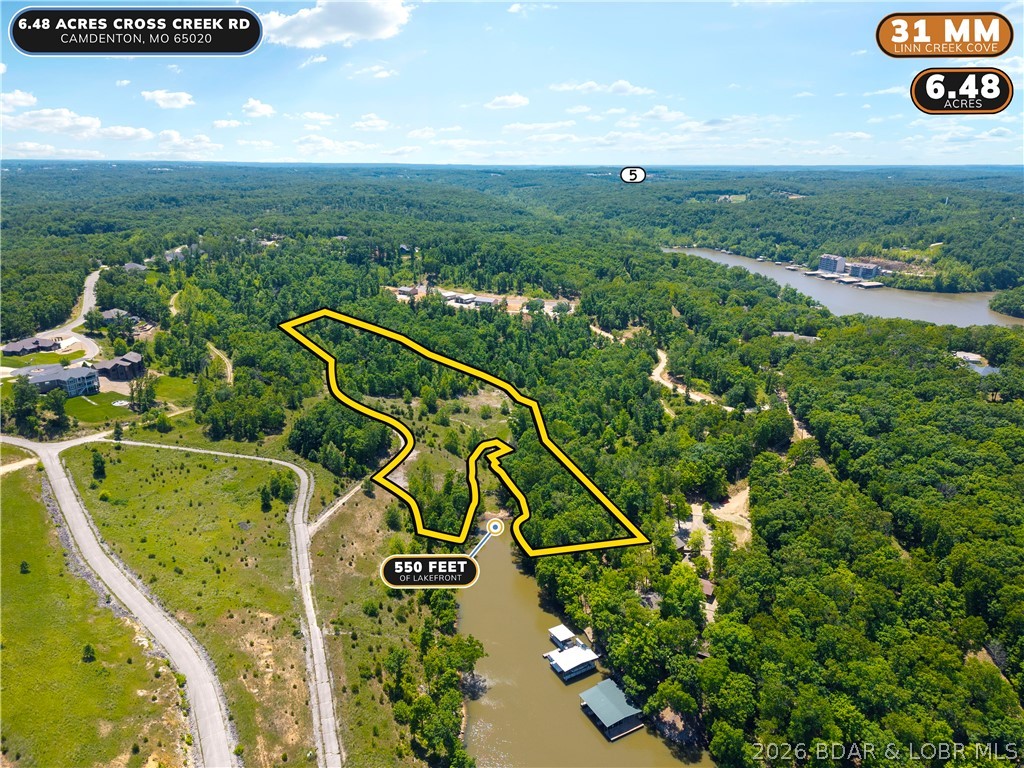Rare opportunity to own one of the most impressive lakefront parcels to hit the market at Lake of the Ozarks. Over 550 feet of lake frontage on Linn Creek Cove at MM 31 with 6.48 acres of open and wooded ground, gentle to moderate terrain, and stunning cove views in every direction. Zoned PUD, giving a future owner exceptional flexibility for a private estate or residential development. The cove width supports two dock structures and preliminary dock drawings are available showing what could be permitted here. If you have been searching for the right canvas to build something extraordinary at the lake, this is it.