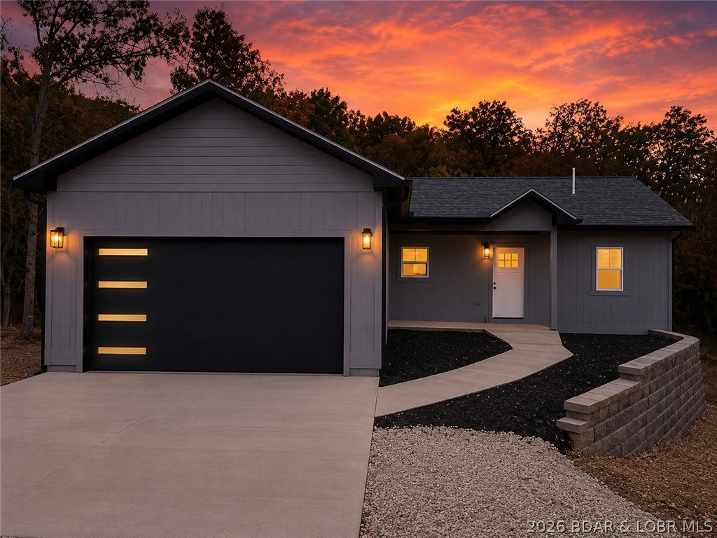 Woodhaven Estates is growing — & this home is positioned right in the middle of that momentum. With confirmed neighborhood amenities coming soon, including a playground & designated dog area, residents will have even more to enjoy close to home. Located within Laurie city limits & the Camdenton School District, this brand-new 4-bedroom, 3-bath home offers a flexible layout designed for everyday living. The main level features vaulted ceilings, upgraded cabinetry, a large center island, & a private primary suite with dual sinks, walk-in closet, and walk-in shower. The finished walkout lower level adds a second living area, two additional bedrooms, a full bath, storage space, & a bonus flex room ideal for a home office, gym, playroom, media room, or non-conforming 5th bedroom. Outside, enjoy a covered front porch, elevated back deck, lower-level patio, oversized 2-car garage, city water/sewer, & high-speed Co-Mo internet. The seller is also offering a $2,000 landscaping allowance so buyers can personalize the exterior. New construction, flexible space, city utilities, internet, & neighborhood amenities on the way — this one offers more than buyers may realize at first glance.