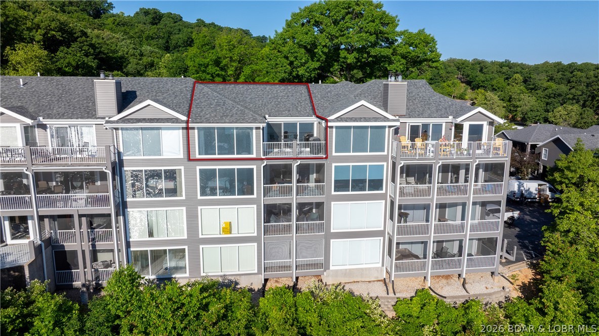 Absolute BREATHTAKING view as soon as you step into this top floor unit; one of the best views for a complex in Lake of the Ozarks! This TURNKEY 2bed/2bath condo towers over the Osage 34 mile marker where you get to enjoy AMAZING sunsets; so good you could frame them! Updates were completed completed updated just 4 years ago but is so well taken care of it looks like it was just done yesterday! Not only the inside redone but outside will have all new siding, roof, windows, trim, beams, gutters,  downspouts and parking lots! Tastefully designed with LVP flooring, SS appliances, vaulted ceilings & nice fixtures throughout. Primary suite features floor to ceiling windows all along the lakeside, spacious room, large walk-in closet & an additional fridge in closet! On the deck you have a great entertainment atmosphere where you'll never set sick of the view. Amenities include a huge pool deck area, spacious clubhouse great for large gatherings, exercise equipment, tennis court w/ basketball hoop & your own 12x30 slip in the cove protected community docks w/ wave-break. Great location by land & water; close to Captain Ron's, The Cave, Larry's on the Lake, Bear Bottoms & The Fish!