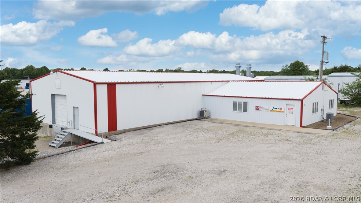 Exceptional commercial opportunity just outside Osage Beach city limits in Kaiser, offering flexibility, prime access being only minutes from town & right off Hwy 42! Situated on a flat 0.89-acre lot, this well-maintained property features a 40x100 shop with attached 1,520 sq ft office space. Office includes 3 private offices, bullpen workspace, conference room, media/server room & 2 restrooms (1 ADA). Another 3 additional office spaces in the shop section of the building. Breakroom offers kitchenette, cabinets/counters & dining area. Shop features concrete floors, 13’ walls with 16’ at the peak, 12x12 & 12x10 garage doors plus loading dock with ramps. Equipped with 400 amp service & 208 3-phase electric in shop area. Two HVAC systems, high-speed internet, security system & dusk-to-dawn lighting. All interior walls in shop area are non-load bearing, allowing you to reconfigure the space and operate virtually any business with ease. Flat parking, drive-around access & incredible location! Metal building with 2014 roof. Clean, versatile for businesses & move-in ready!