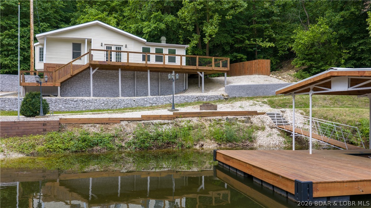 Back on the Market at NO Fault of the Seller. Discover the perfect blend of privacy, potential, & lake lifestyle w/this unique property situated on nearly 3 peaceful acres w/a private boat ramp & new dock just steps away. Major improvements have already been completed, giving buyers peace of mind + a strong head start on creating their own lake retreat. Upgrades, all NEW: HVAC; well pump; refurbished well house, updated & inspected electrical; sump pump; enlarged deck; sliding door, septic tank w/laterals checked; garage door & extensive exterior improvements. Extra features are a large 2 car garage, shed, shooting range, abundant parking for boats/trailers & a quiet setting perfect for full-time living or weekend escapes. Inside has been dry-walled, painted & ready for your finishing touches, allowing you to customize the home to your personal style. A contractor is available to complete the interior for approximately $25,000 in labor plus materials, or finish it yourself & build instant equity. Hard-to-find combination of acreage, privacy, lake access, & major updates already complete makes this property a rare opportunity! *See rental projection in attachments.