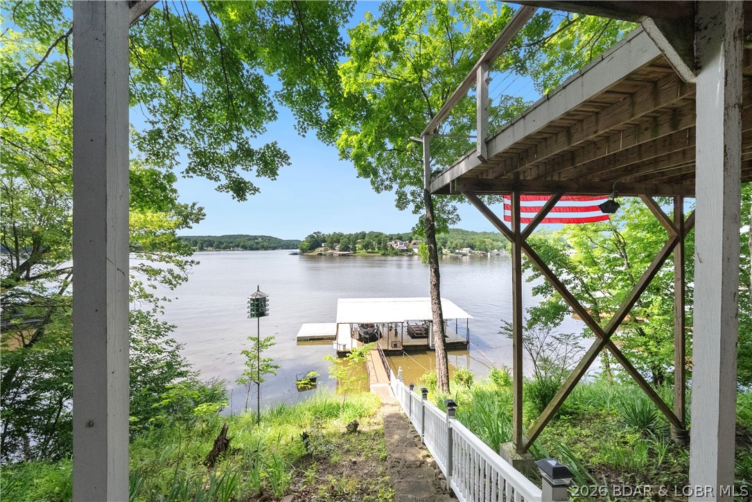 Affordable waterfront living on the Little Niangua! This charming 1 bed, 1 bath fishing cabin offers approximately 140 feet of shoreline and everything you need for the perfect lake getaway. Spend your days relaxing on the oversized deck overlooking the water or take in the views through the large picture window. Inside, you'll find two full-size Murphy beds, new laminate flooring, new windows, and a reverse osmosis water filtration system. Outside, the spacious, tree-shaded lot features mature walnut trees and natural Ozark stone steps leading to the shoreline. The property includes a large dock with a swim platform, a 10x24 boat slip, and a 12x20 boat slip. A convenient public boat ramp at the end of the street makes launching your boat quick and easy. Being sold furnished, this move-in-ready cabin is a rare opportunity to own an affordable slice of lakefront paradise.