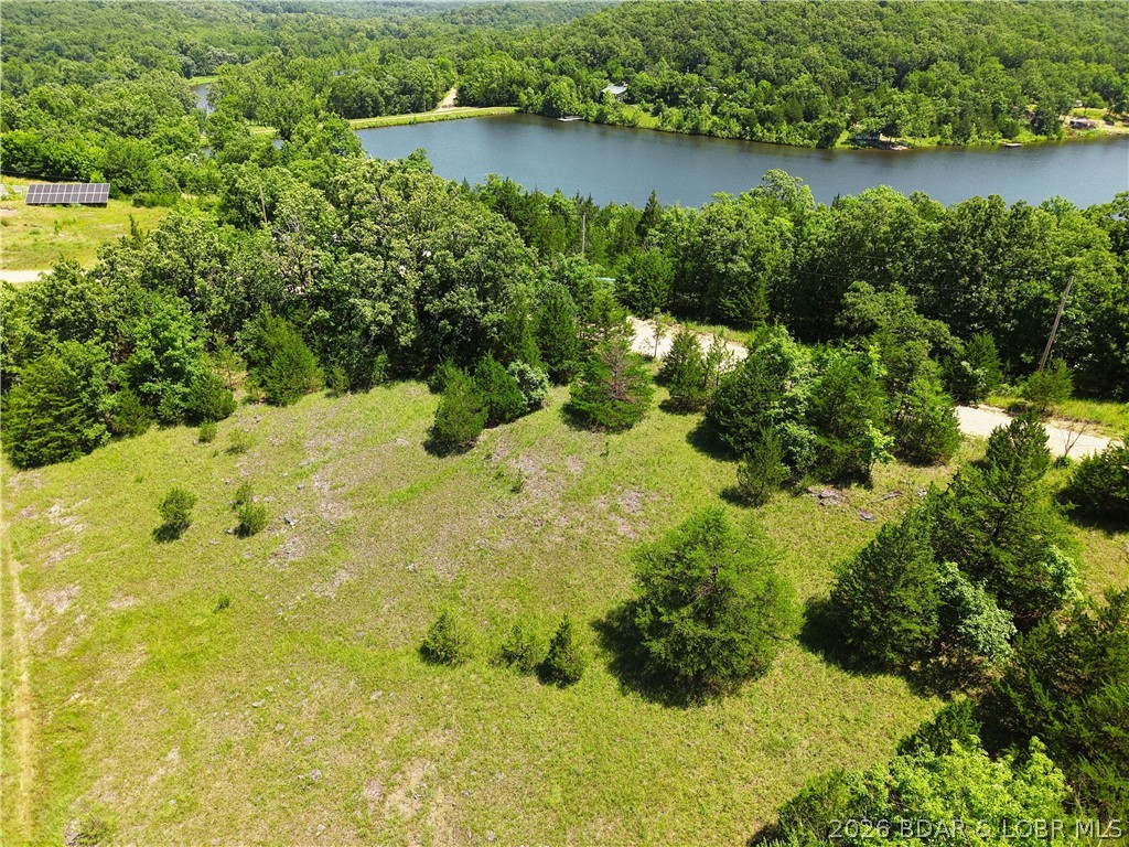 Build your getaway in the heart of Indian Creek Hills! This mostly clear **0.28-acre lot** sits atop the hill, offering beautiful long-range views and an excellent building site with minimal prep work.

Ownership includes access to **both Lake Pocahontas and Lake of the Ozarks**, giving you the best of both worlds. Spend your days fishing, kayaking, swimming, or relaxing on the private spring-fed waters of Lake Pocahontas, then launch onto Lake of the Ozarks for boating, waterfront dining, and endless recreation. Property owners also enjoy access to community hunting grounds, campground facilities, showers, restrooms, and a community boat launch, making this a fantastic spot for weekend escapes or future full-time living.

Conveniently located just minutes from restaurants, a convenience store, Dollar General, and Coffman Beach, this property offers peaceful surroundings without sacrificing accessibility. Whether you're planning to build a cabin, a full-time residence, or simply want a place to enjoy everything the Lake area has to offer, this lot is ready for your vision.