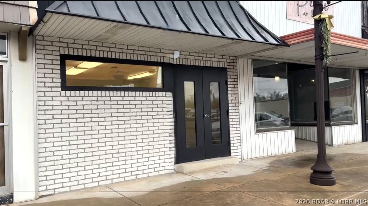 Prime your business for success at 11 S Maple in Eldon! This beautifully updated commercial building is truly move-in ready, offering a clean, modern space ideal for a wide range of business opportunities. Major improvements include:liquid rubber roof installed by Black & White Roofing (finished in white for enhanced energy efficiency), HVAC installed by Wyrick HVAC.  Fresh flooring, drywall and paint, an updated front window, and upgraded restroom fixtures including a sink and toilet. The exterior has an attractive real brick façade, NS routine pest service has kept the property well-maintained. Constructed with durability in mind, the building features a solid slab foundation, cinder block walls, and a steel frame structure. The functional layout includes a welcoming lobby, two main offices, a storage closet, a bathroom, a spacious third back office, and an additional rear storage room. A gravel parking area in the back adds convenience for staff and clients alike. Located in a growing community with strong employment opportunities, an excellent school system, and a welcoming atmosphere, this is an outstanding opportunity to establish or expand your business in a thriving market.