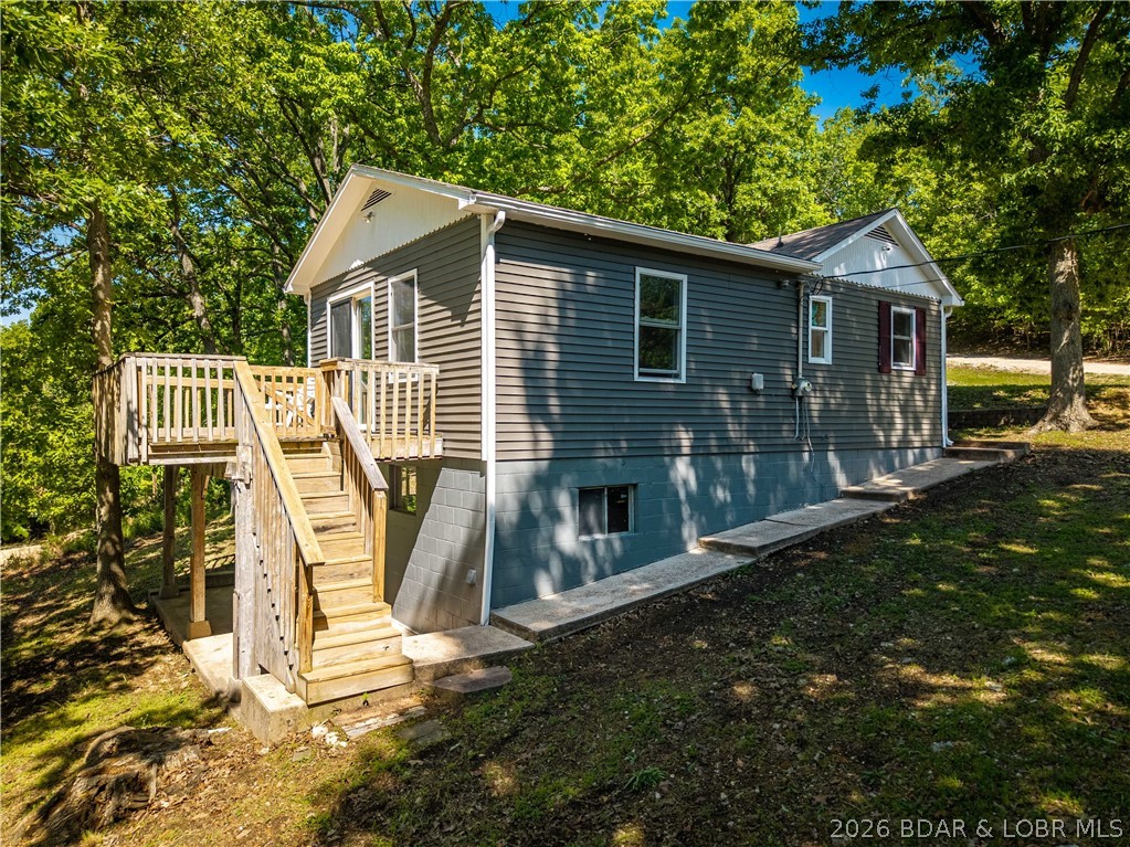 Lake access home with seasonal lake views and updates throughout! This charming 2-bedroom, 1-bath home sits on a nearly half-acre lot in a great neighborhood, offering the perfect blend of comfort, outdoor space, and lake living.  Recent improvements include an updated kitchen and bath, newer flooring, windows, siding, deck boards, and roof—making this home move-in ready. Enjoy relaxing on the spacious deck or entertaining in the large yard with plenty of parking for guests, boats, or trailers.  Lake access is just a short walk away, making it easy to enjoy days on the water. Whether you’re looking for a weekend getaway, investment opportunity, or full-time residence, this property checks all the boxes!